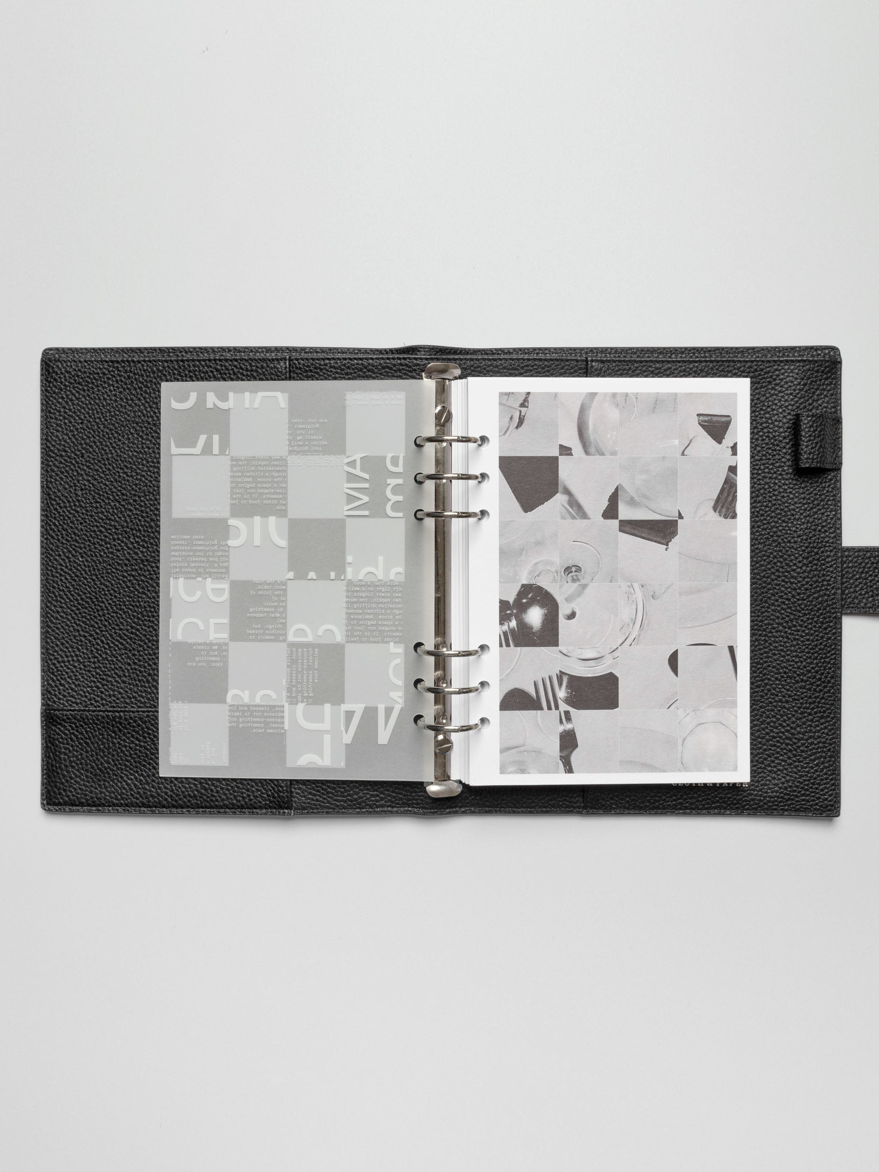 An A5 planner open to the third dashboard of the Ambiance Planner Dashboard trio, featuring an abstract grid with typography elements.