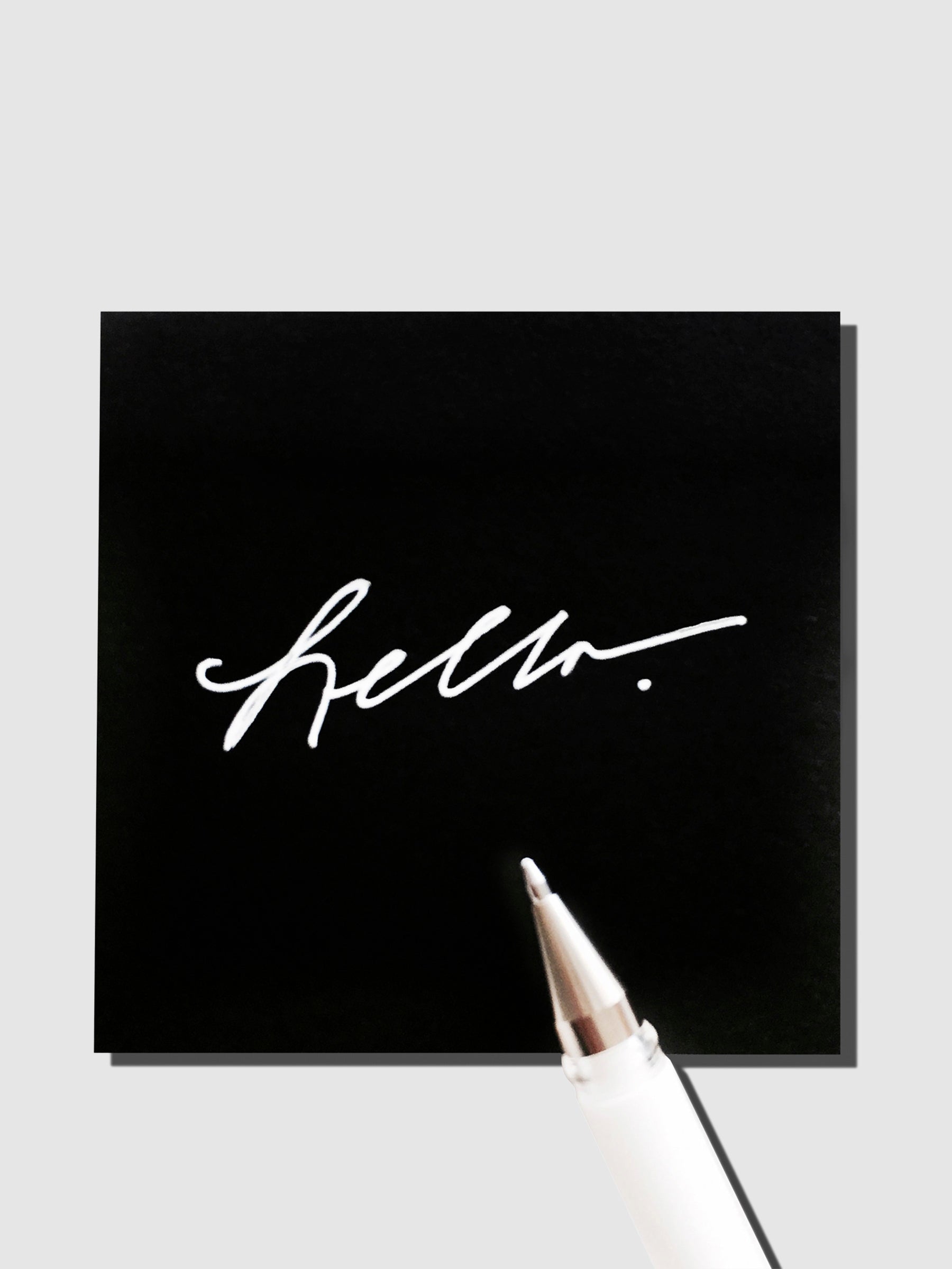 Avant Garde Sticky Notes, Cloth and Paper. Sticky notes with white ink gel pen resting on sticky note pad displaying writing sample.