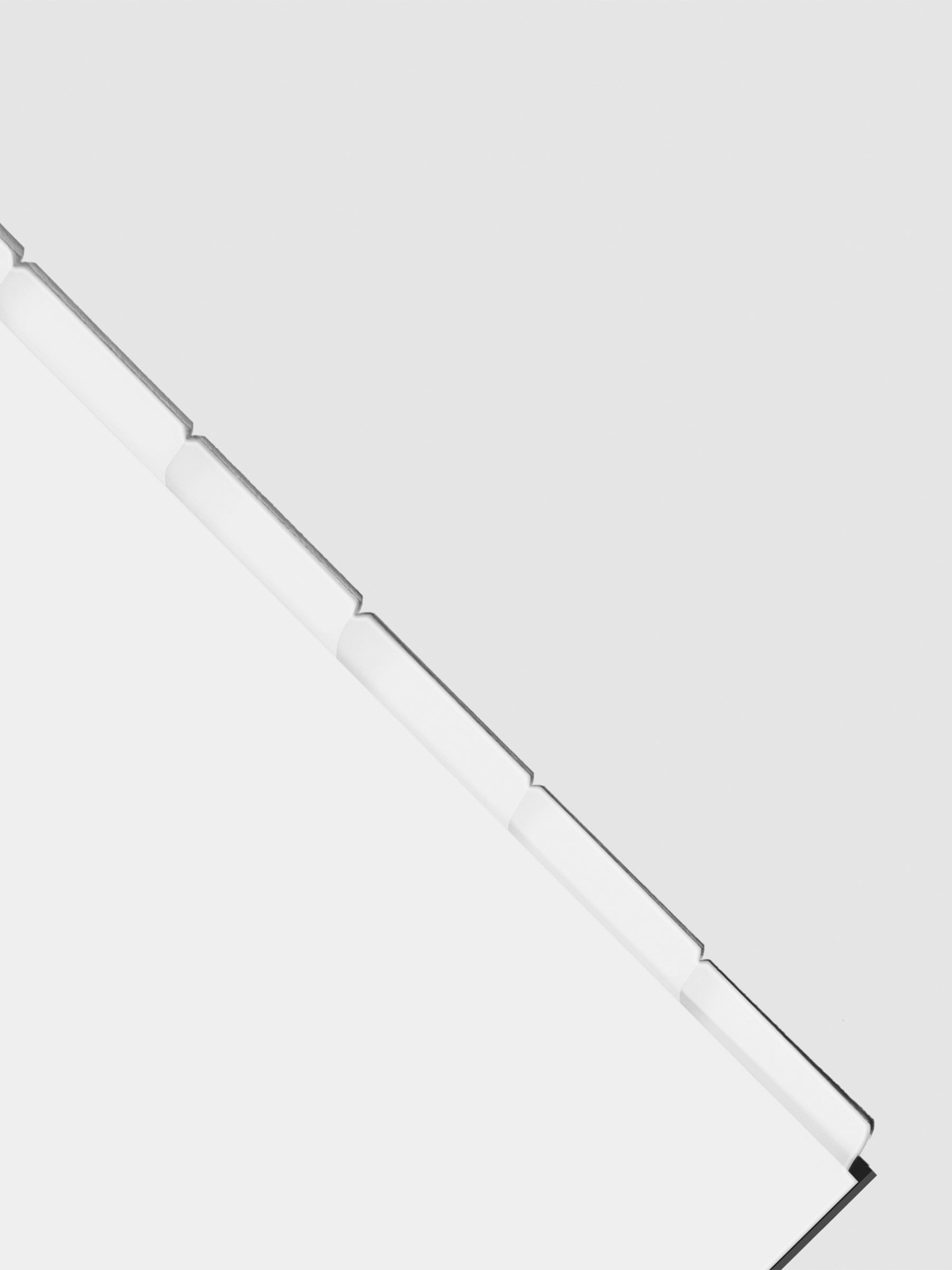 Closeup of blank divider tabs on a neutral background.