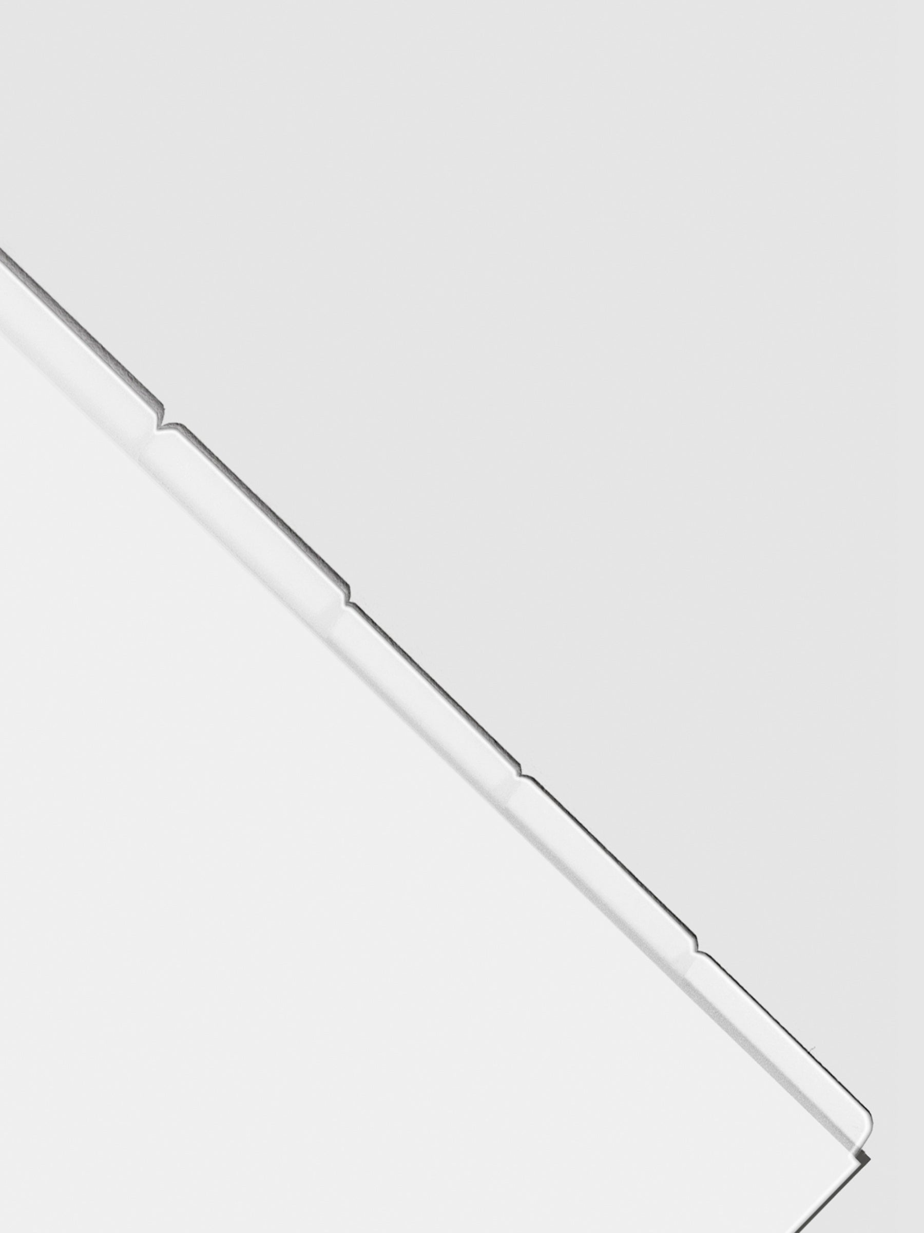 Closeup of blank divider tabs on a neutral background.