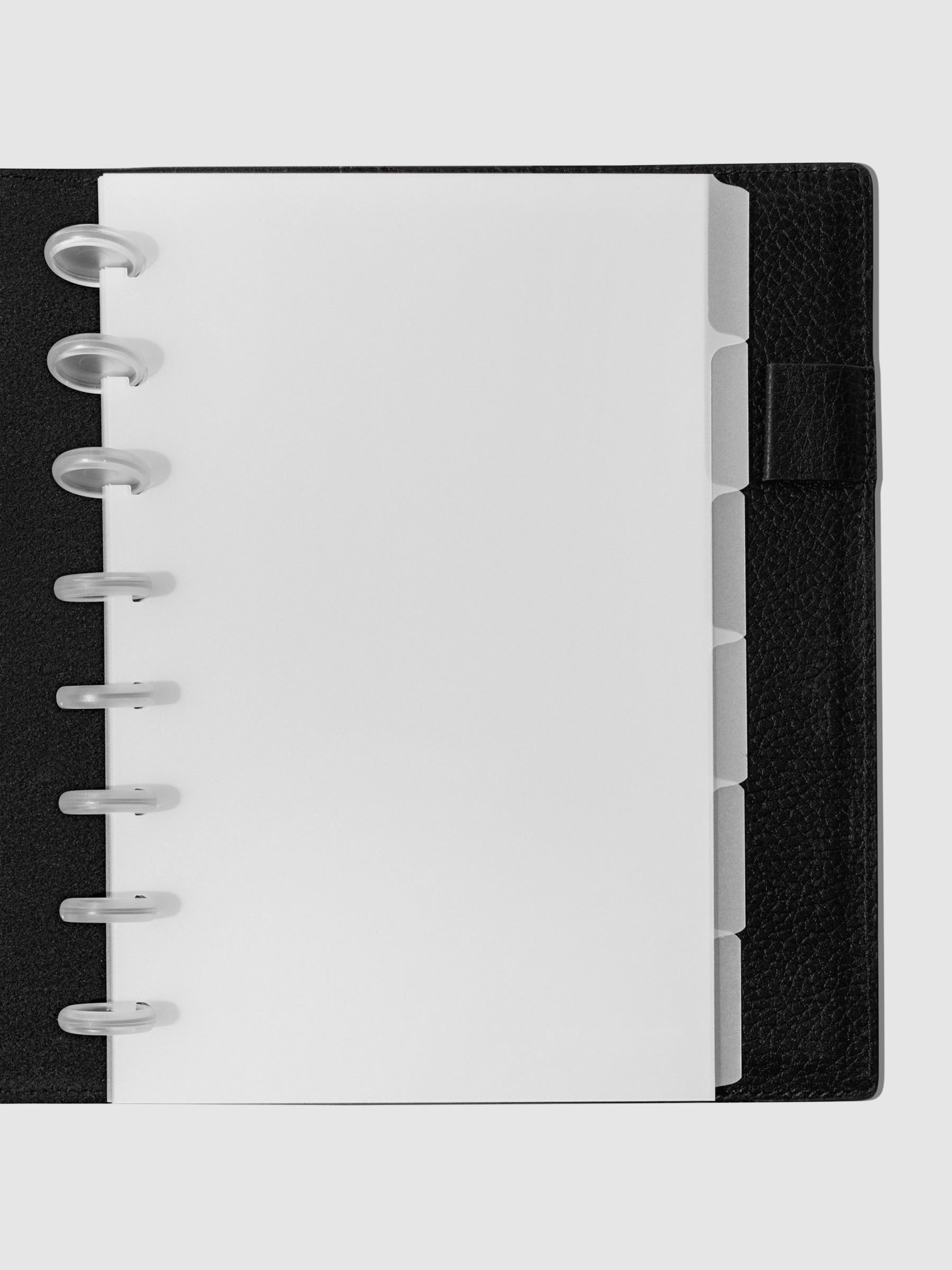 Half Letter Blank side tabs shown in use inside a black leather planner.