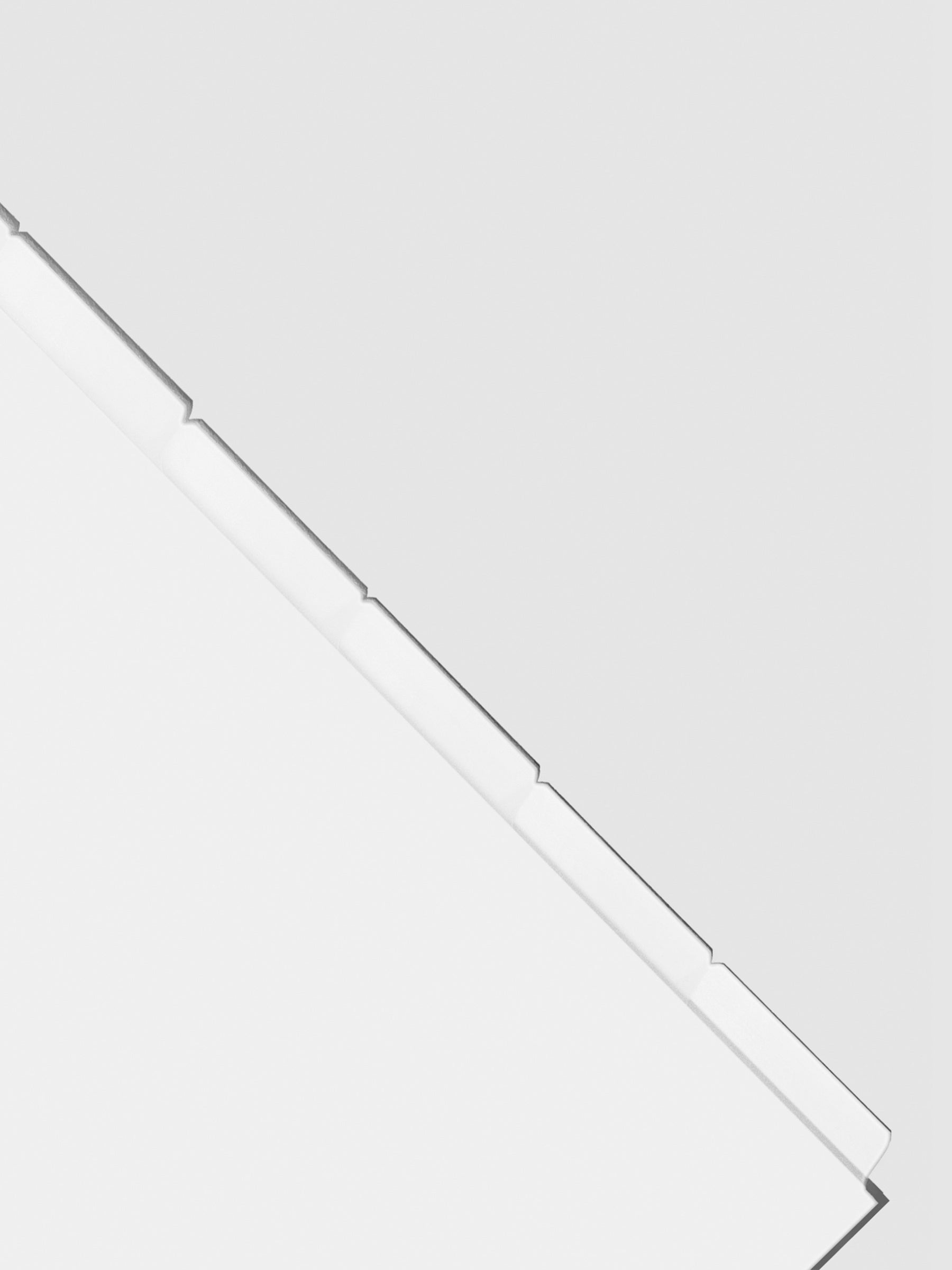 Closeup of blank divider tabs on a neutral background.