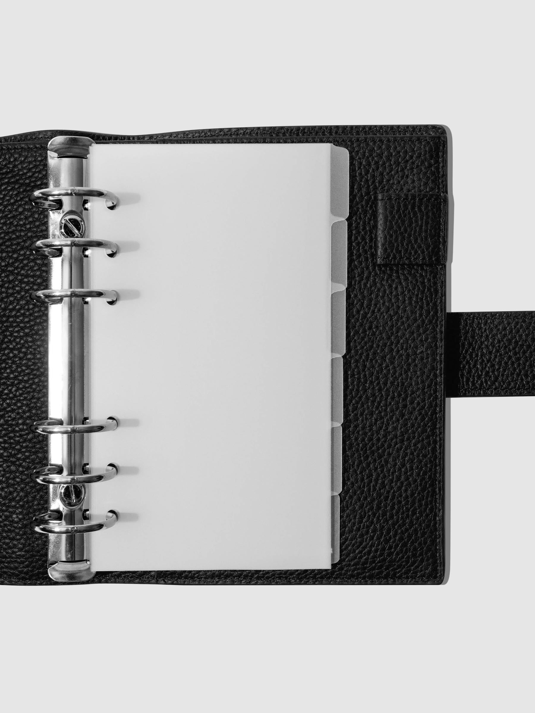 Personal Blank side tabs shown in use inside a black leather planner.
