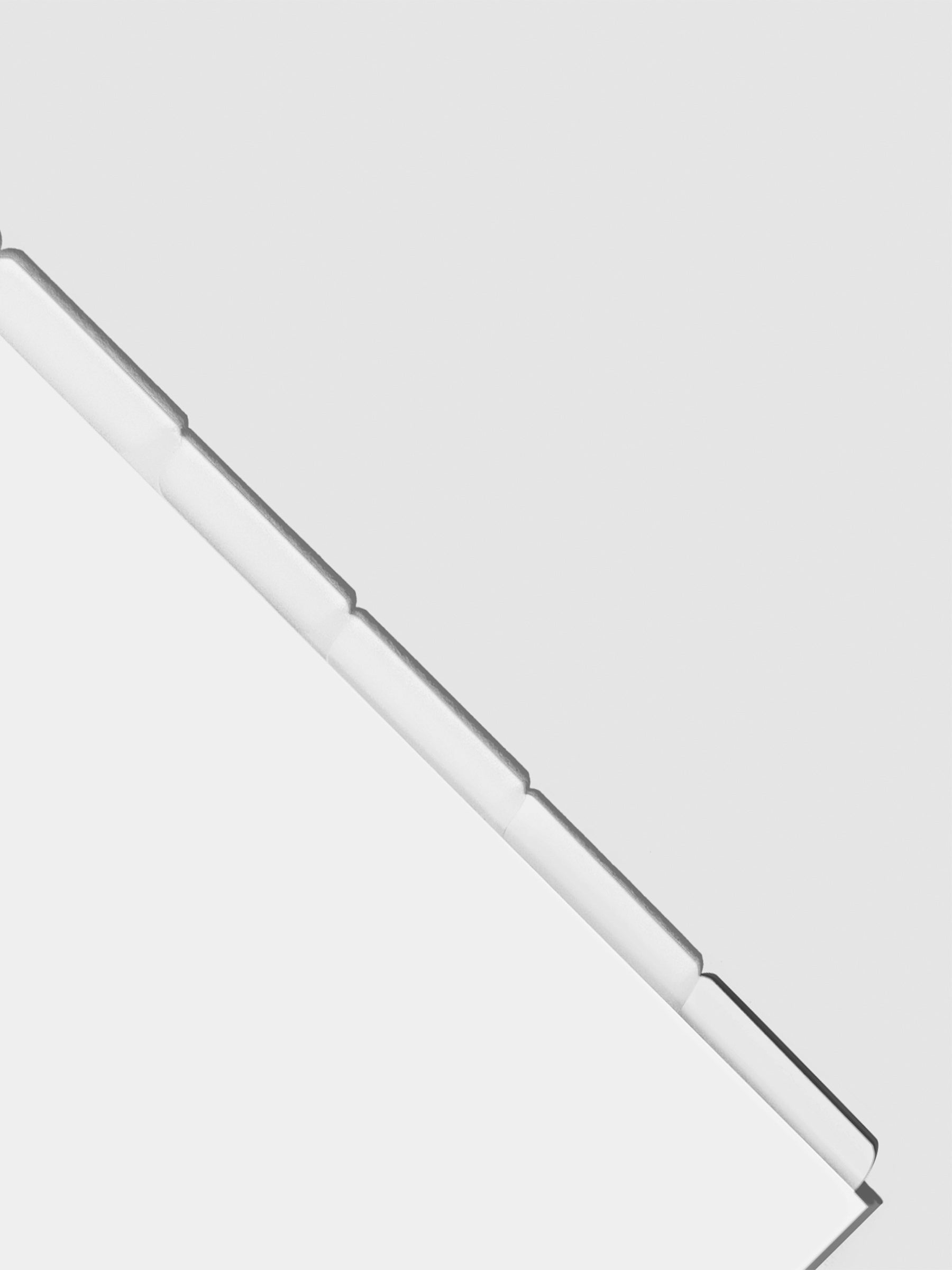 Closeup of blank divider tabs on a neutral background.