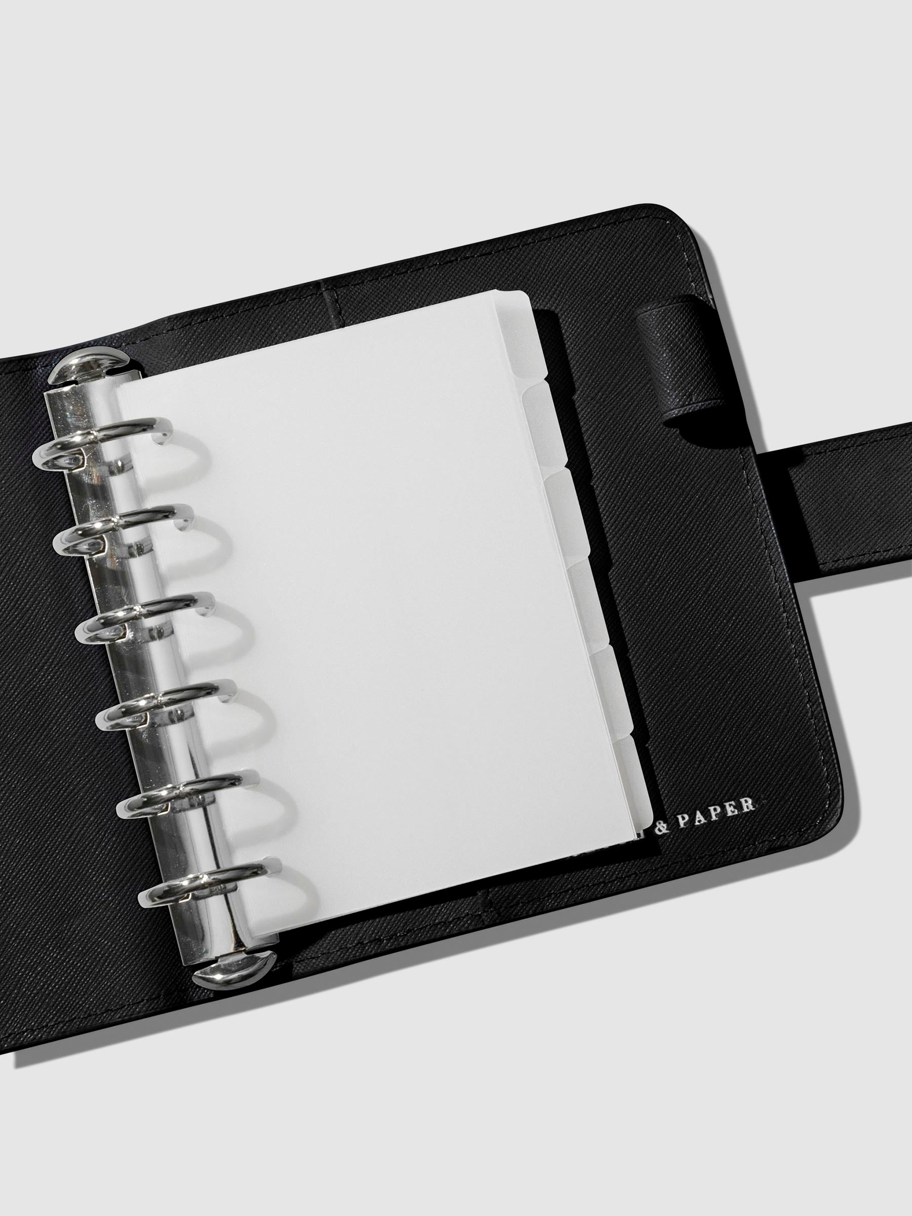 Dividers in use inside a black leather agenda.