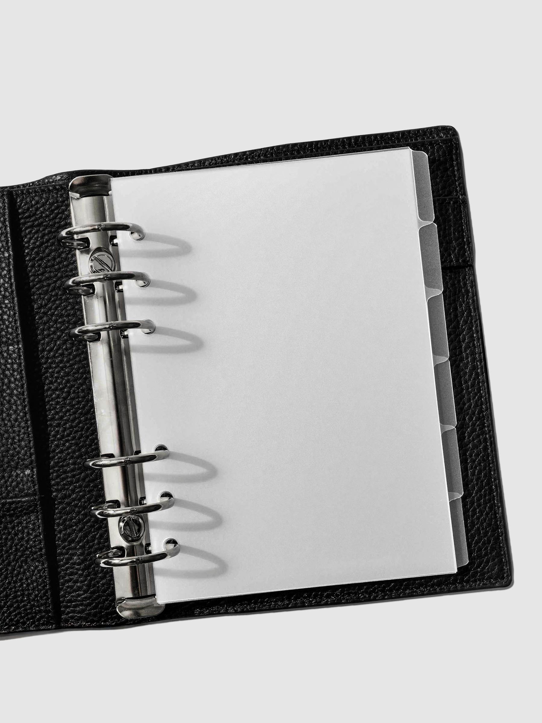 Personal Wide Blank side tabs shown in use inside a black leather planner.