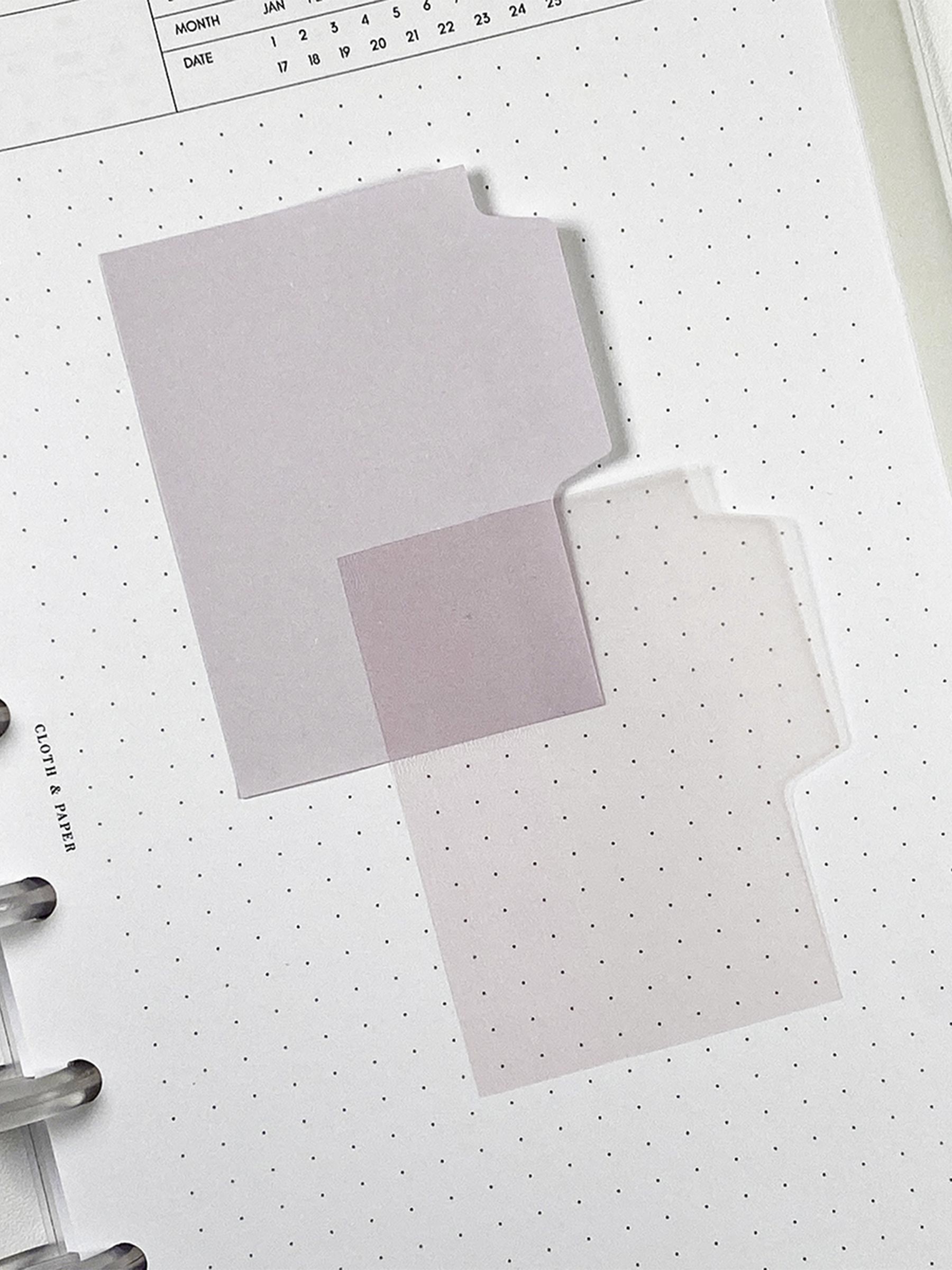 Blank Tab Sticky Note Set, Cotton, Cloth and Paper. One matte and one transparent sticky note from the set placed on a task insert. The transparent sticky note is layered over the bottom right corner of the matte sticky note.