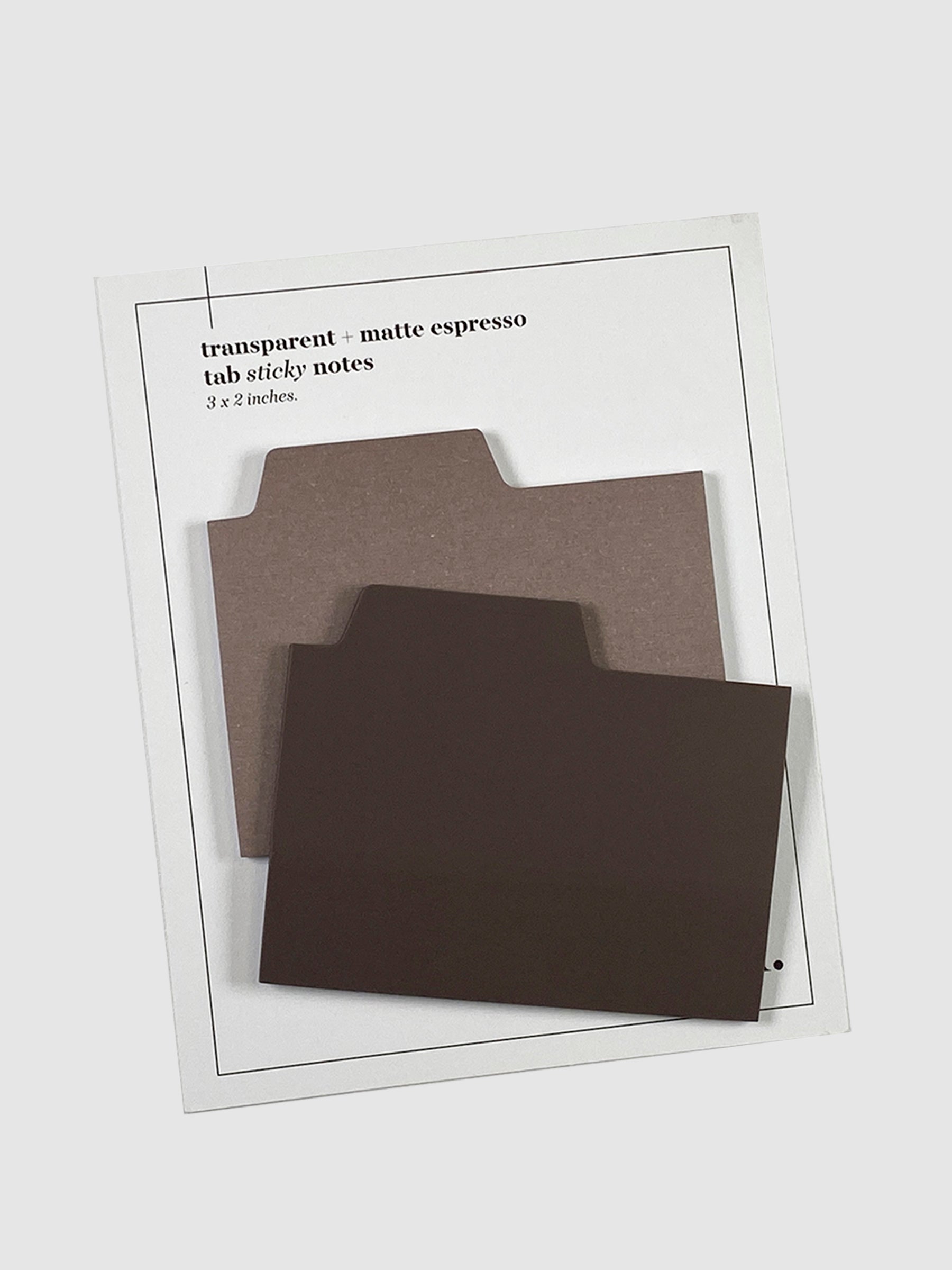Blank Tab Sticky Note Set, Espresso, Cloth and Paper. Sticky note set displayed against a neutral background. The matte sticky note pad is attached to the sticky note backing, while the transparent sticky note pad is layered on top of it, turned slightly to the right.