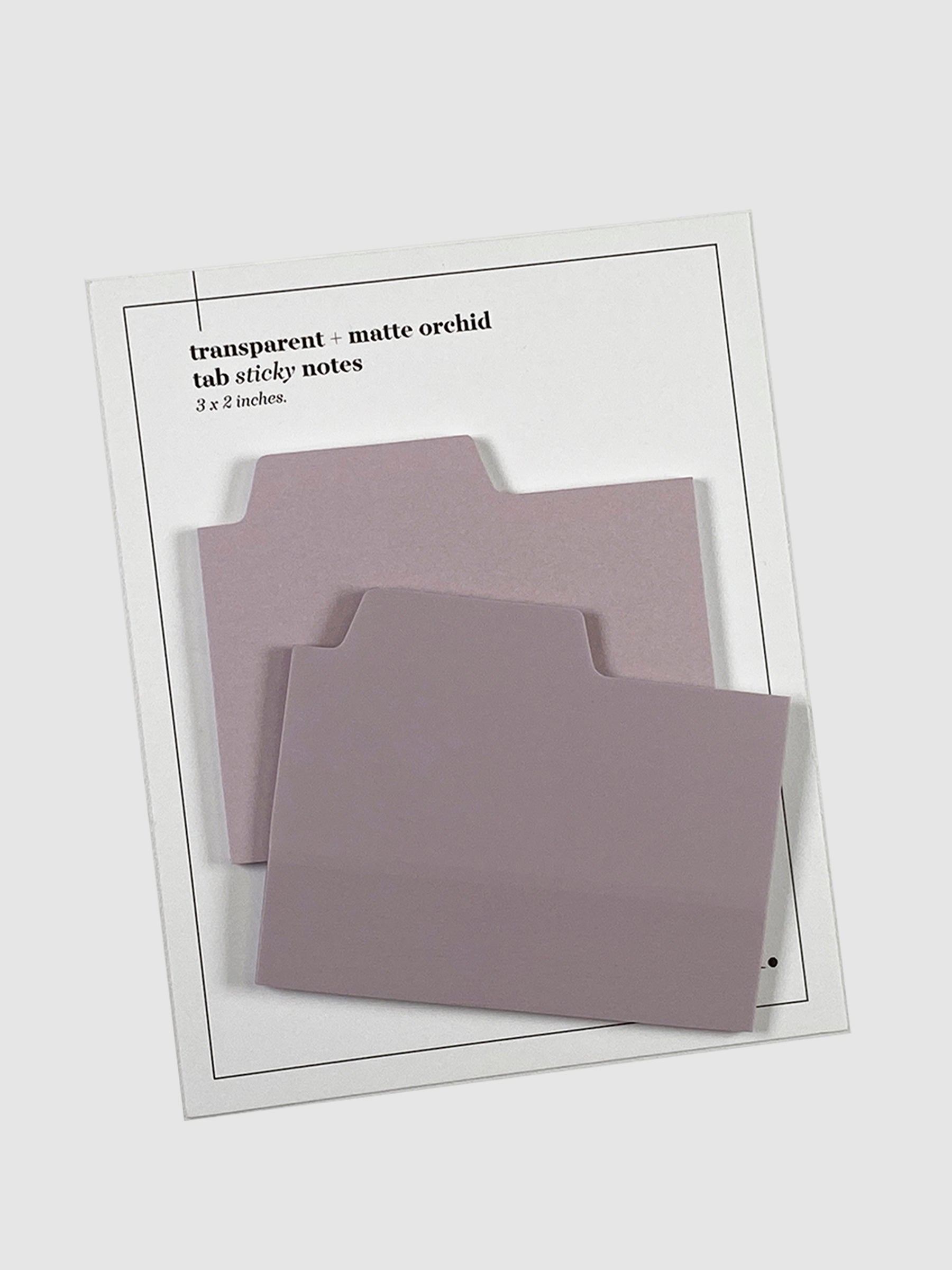Blank Tab Sticky Note Set, Orchid, Cloth and Paper. Sticky note set displayed against a neutral background. The matte sticky note pad is attached to the sticky note backing, while the transparent sticky note pad is layered on top of it, turned slightly to the right.