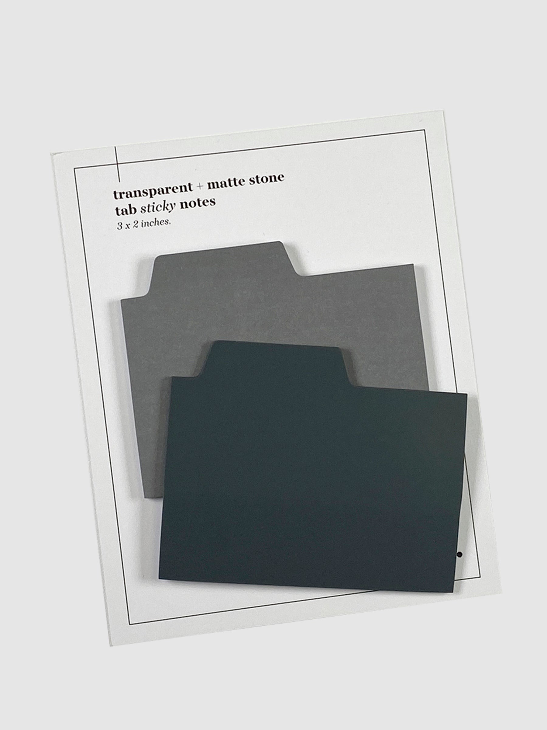 Blank Tab Sticky Note Set, Stone, Cloth and Paper. Sticky note set displayed against a neutral background. The matte sticky note pad is attached to the sticky note backing, while the transparent sticky note pad is layered on top of it, turned slightly to the right.