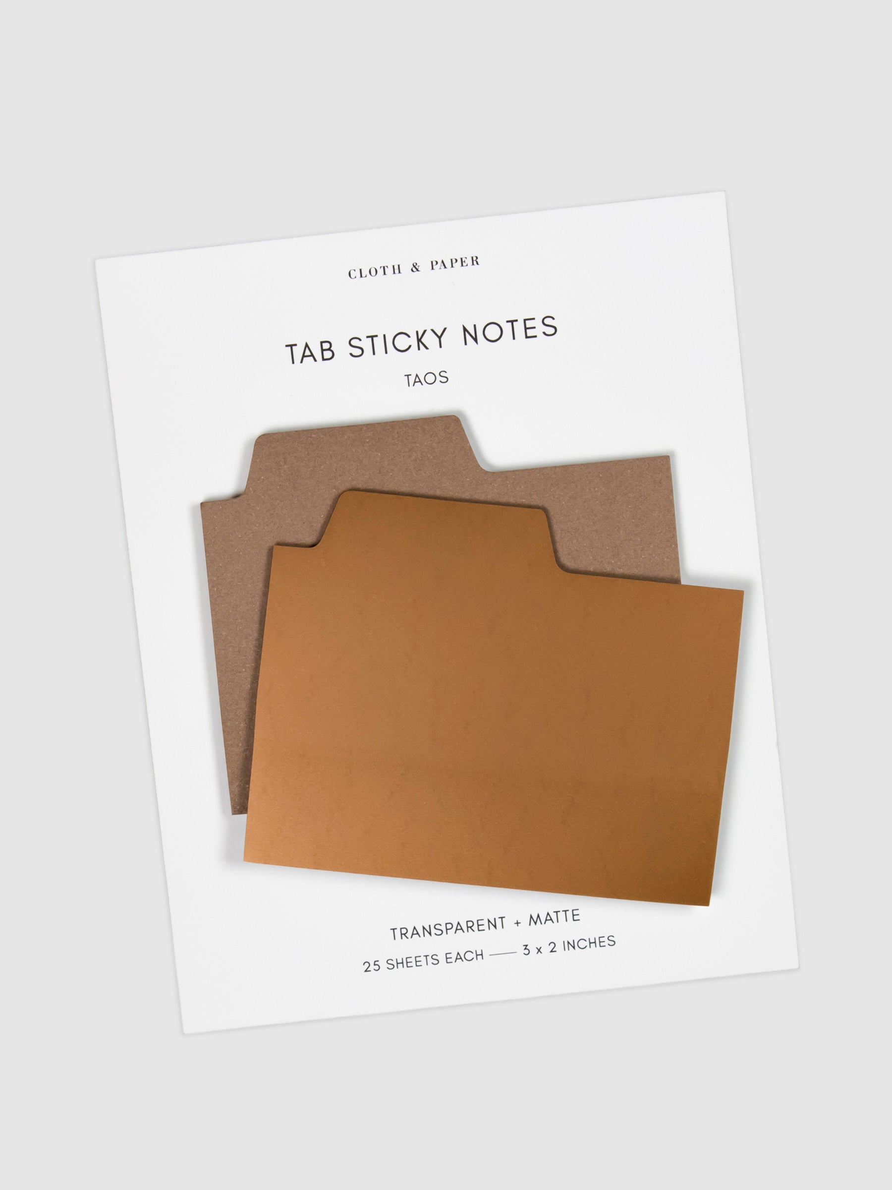 Blank Tab Sticky Note Set, Taos, Cloth and Paper. Sticky note set displayed against a neutral background. The matte sticky note pad is attached to the sticky note backing, while the transparent sticky note pad is layered on top of it, turned slightly to the right.