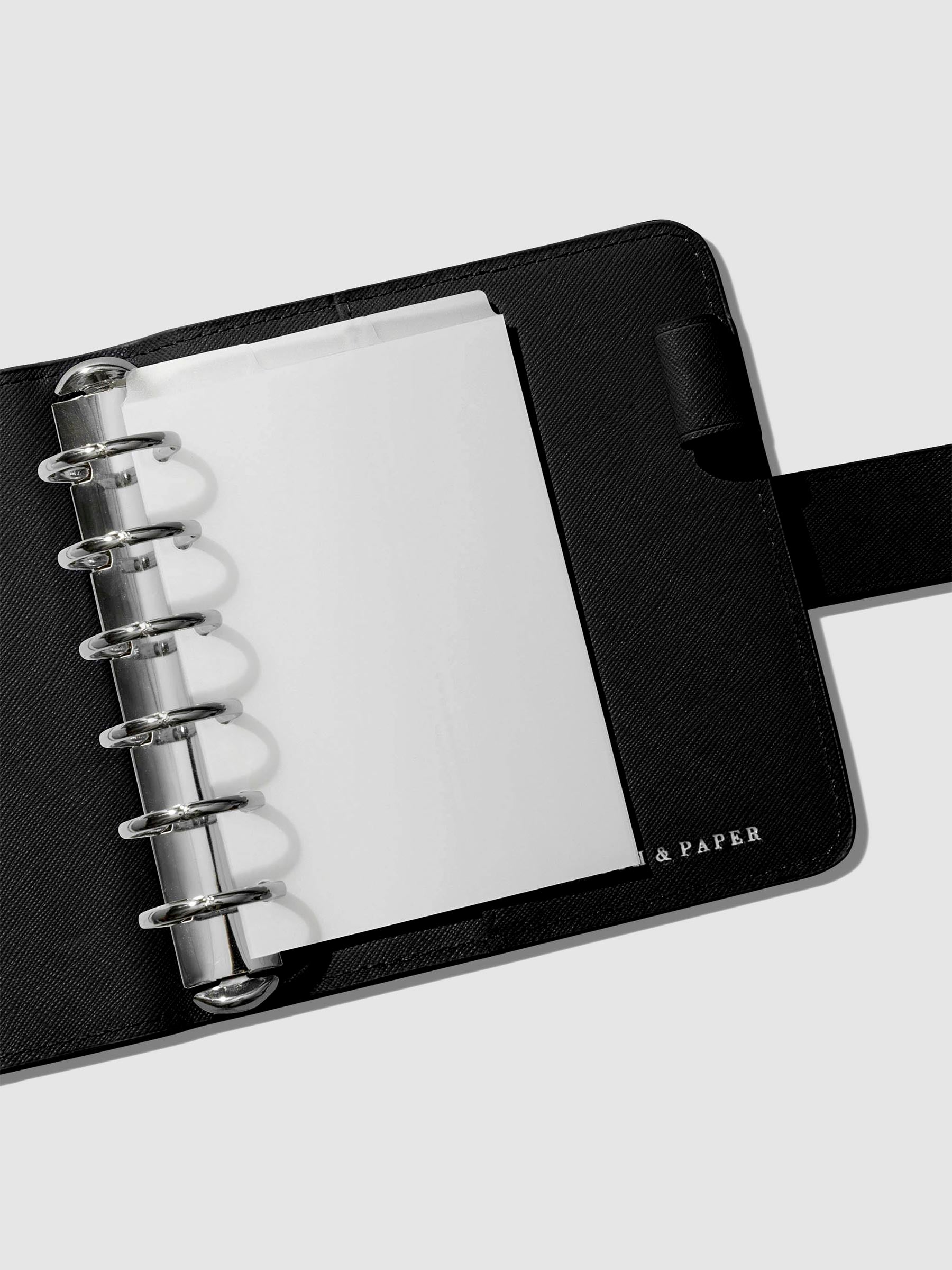 Dividers in use inside a black leather agenda.
