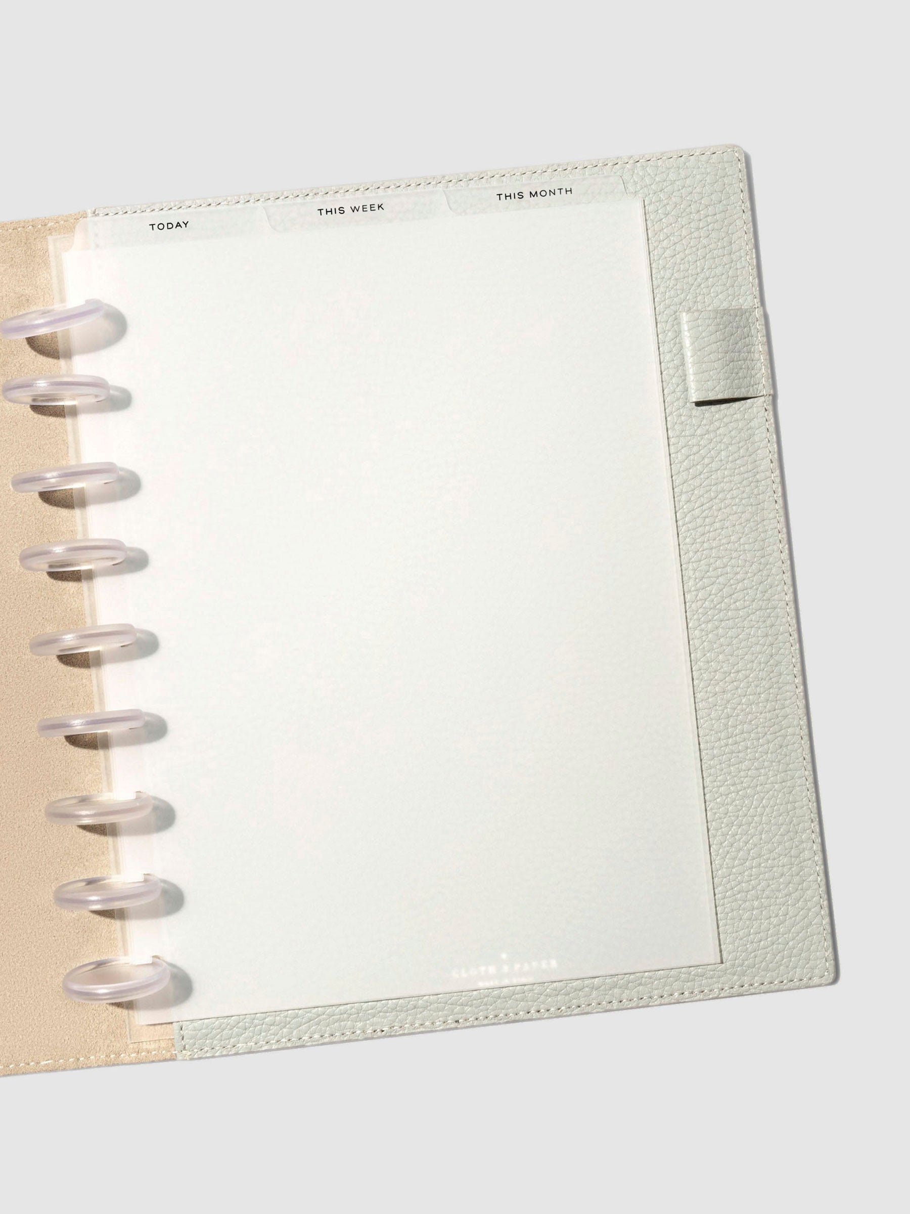 HP Classic Black Foil Cadence Tab Dividers displayed in a gray leather planner.