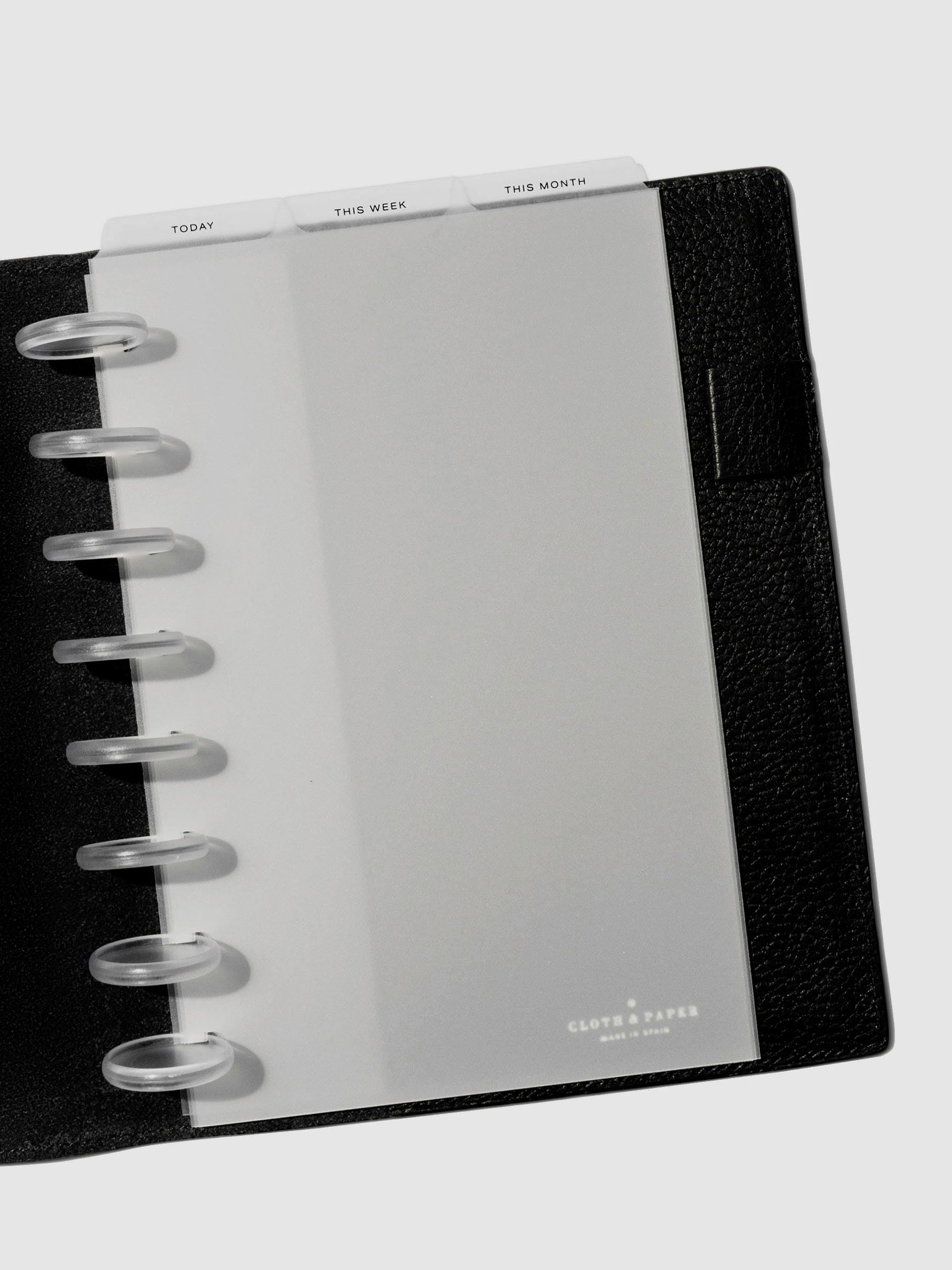 Half Letter Black Foil Cadence Tab Dividers displayed in a black leather planner.