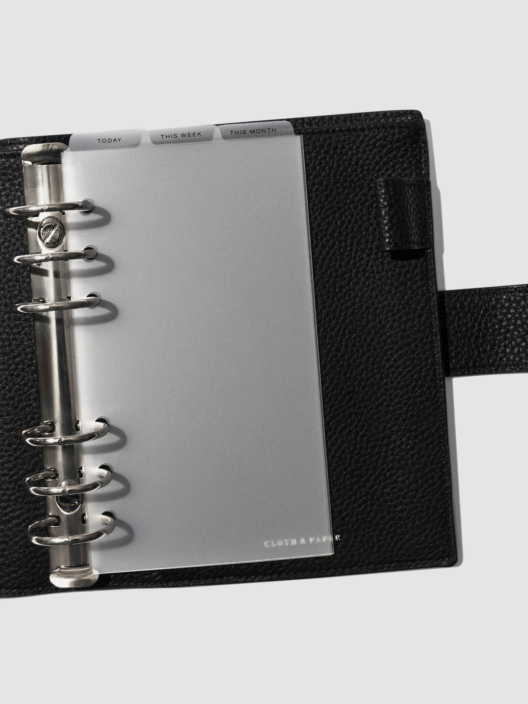 Personal Black Foil Cadence Tab Dividers displayed in a black leather planner.