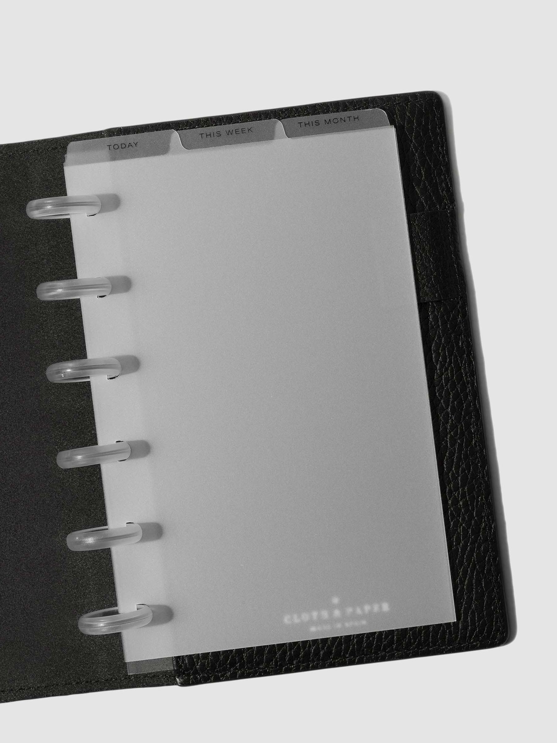 CP Petite Black Foil Cadence Tab Dividers displayed in a black leather planner.