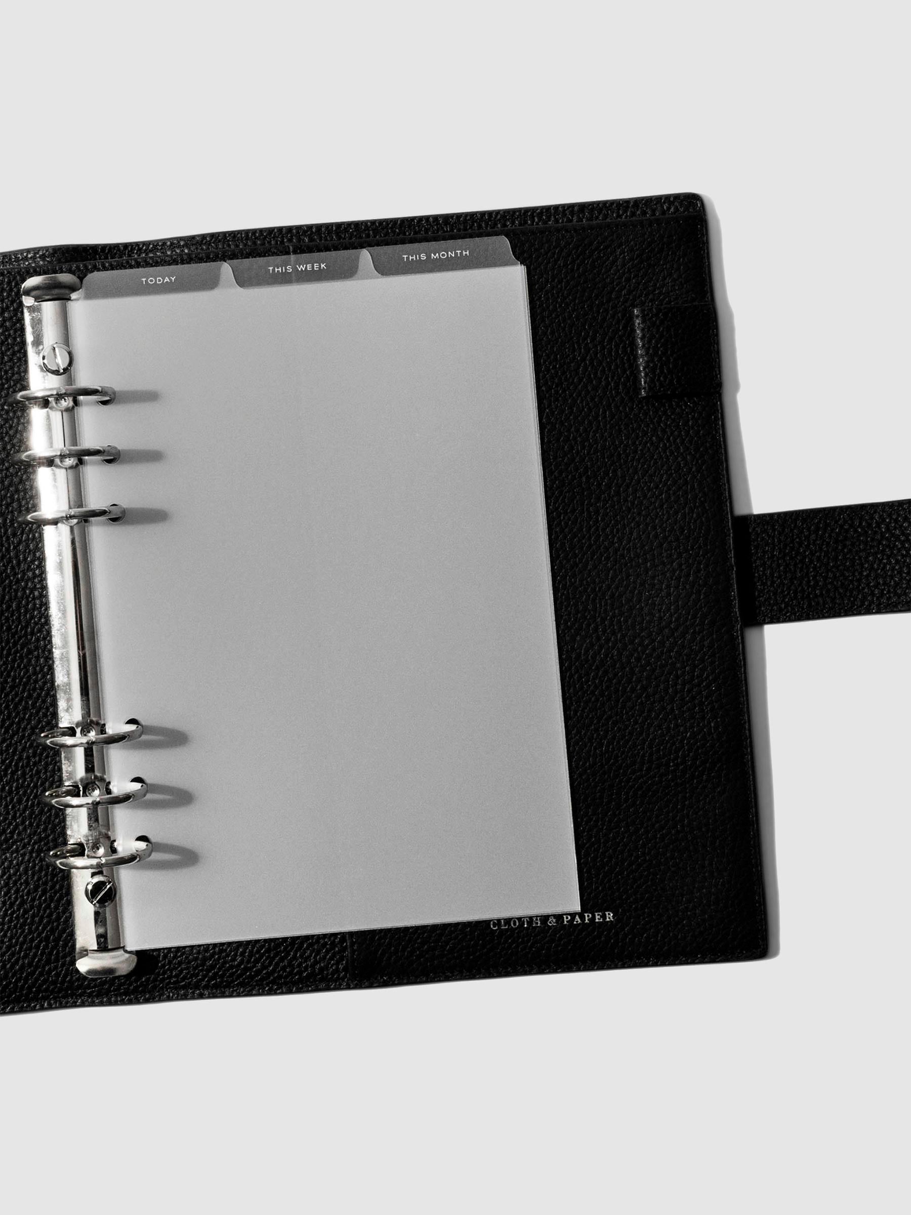 A5 6-Ring White Foil Cadence Tab Dividers displayed in a black leather planner.