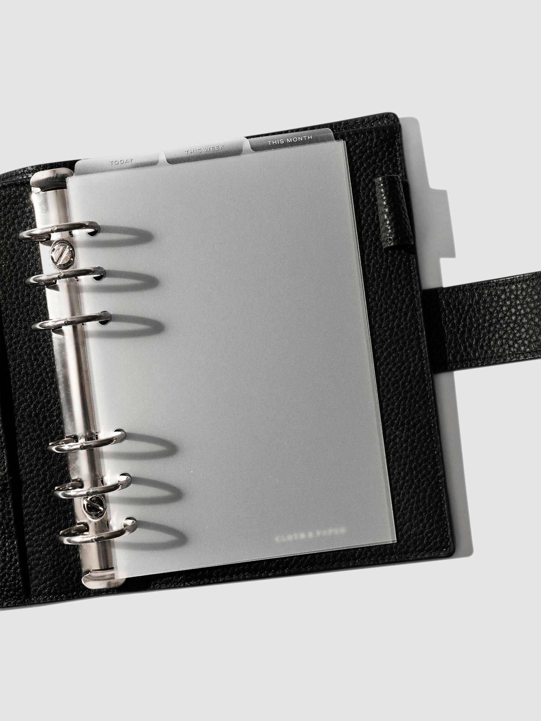 Personal Wide White Foil Cadence Tab Dividers displayed in a black leather planner.
