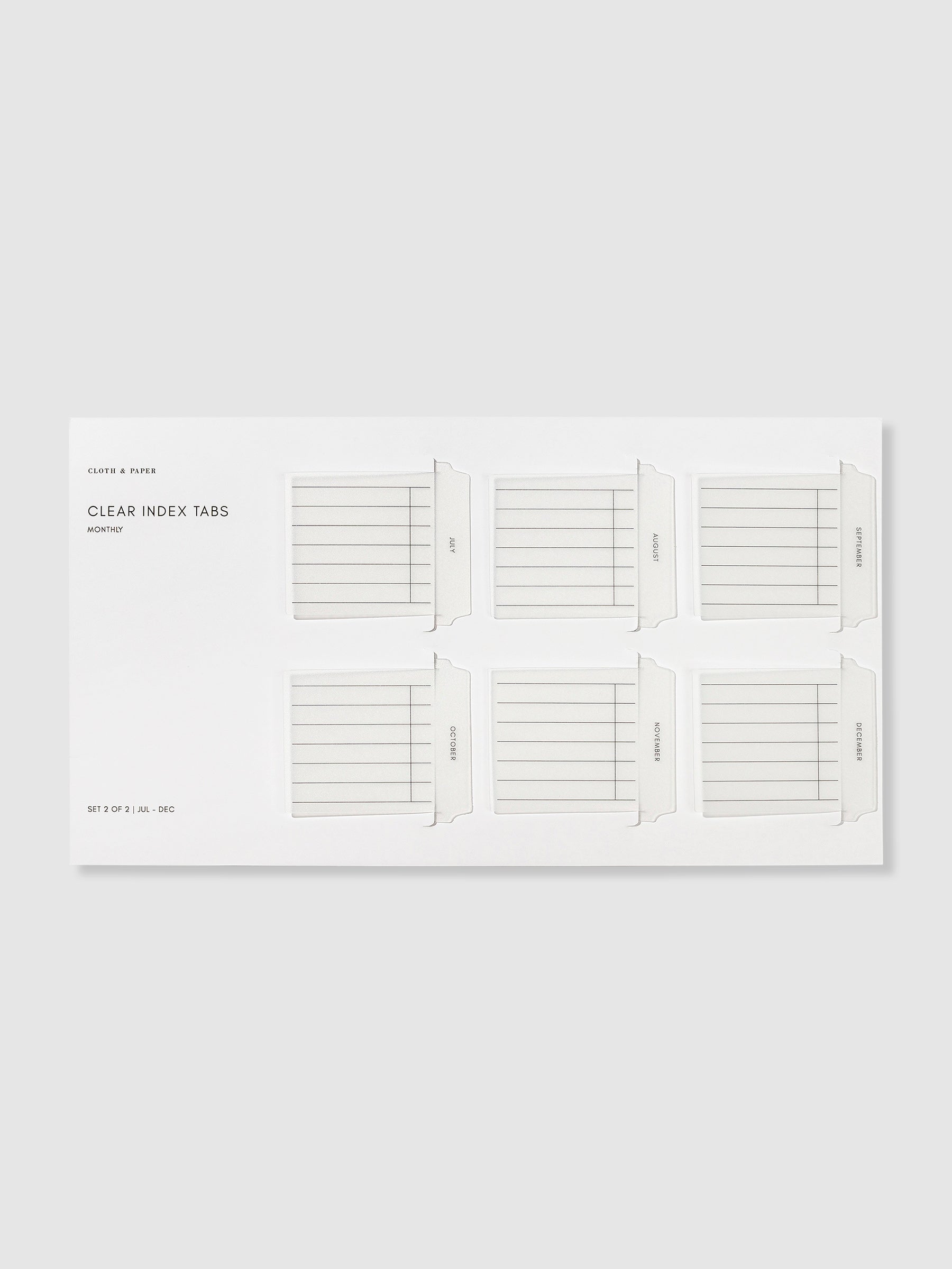 Monthly style Clear Index Tabs in their packaging displayed on a neutral background.