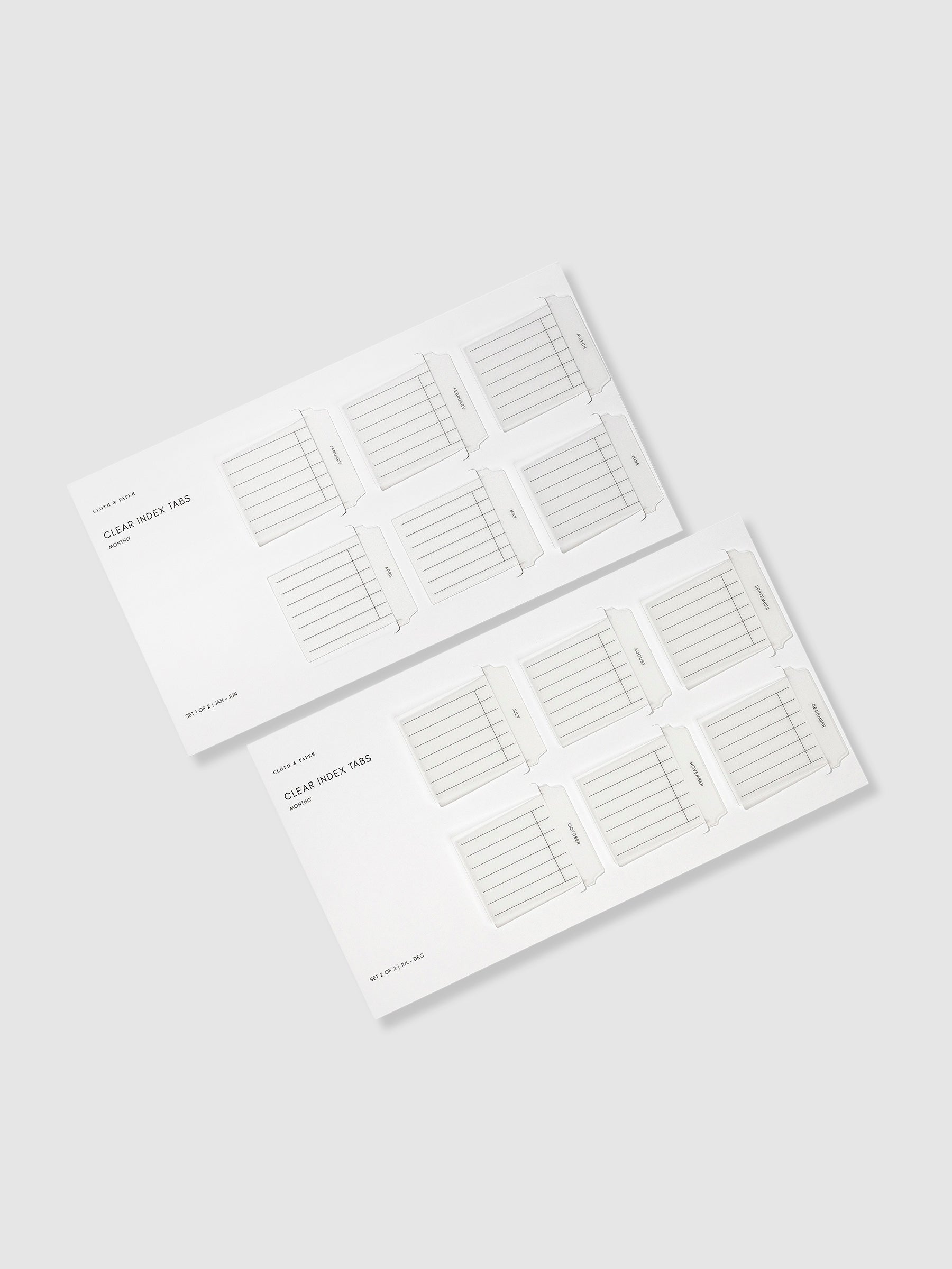 Monthly style Clear Index Tabs in their packaging displayed on a neutral background.