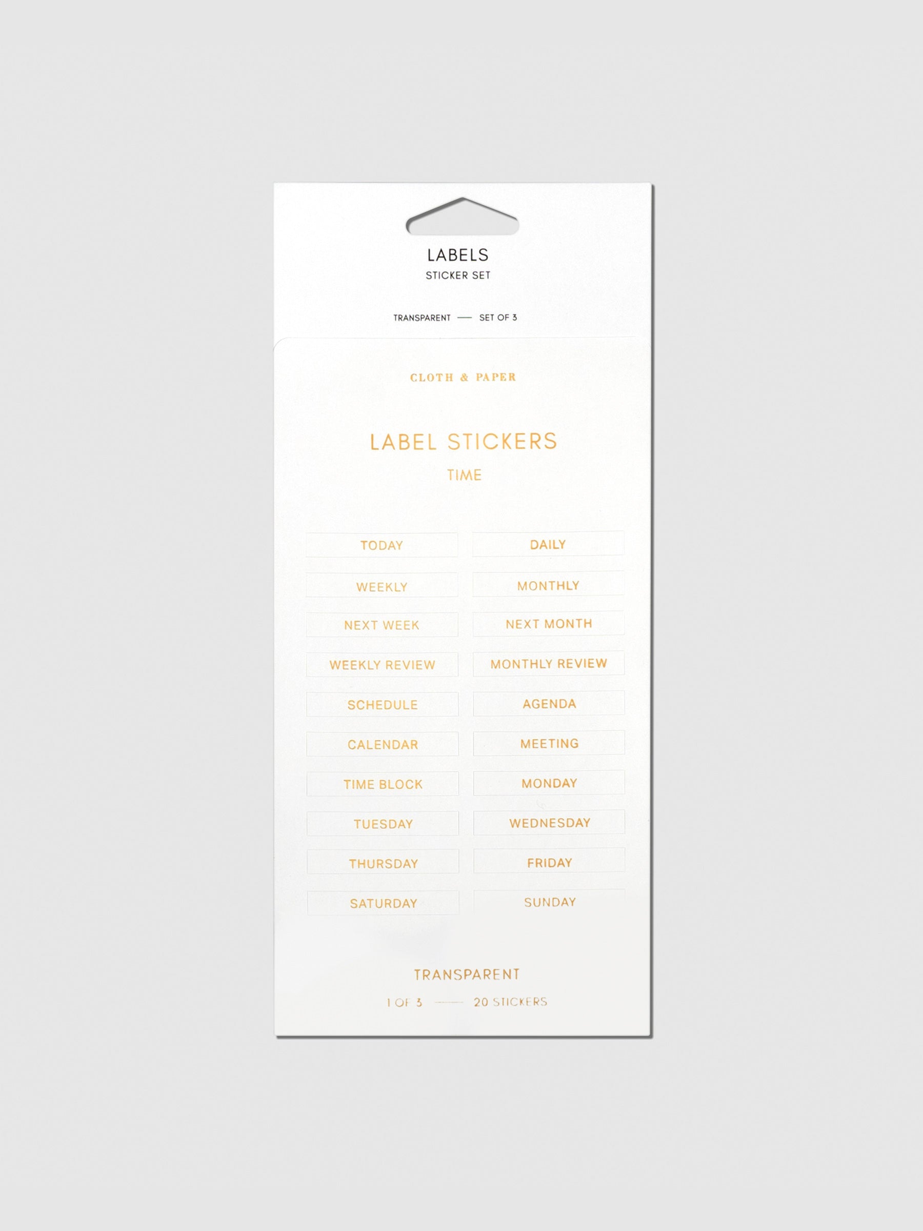 Label stickers in their packaging. The text on each sticker is gold.