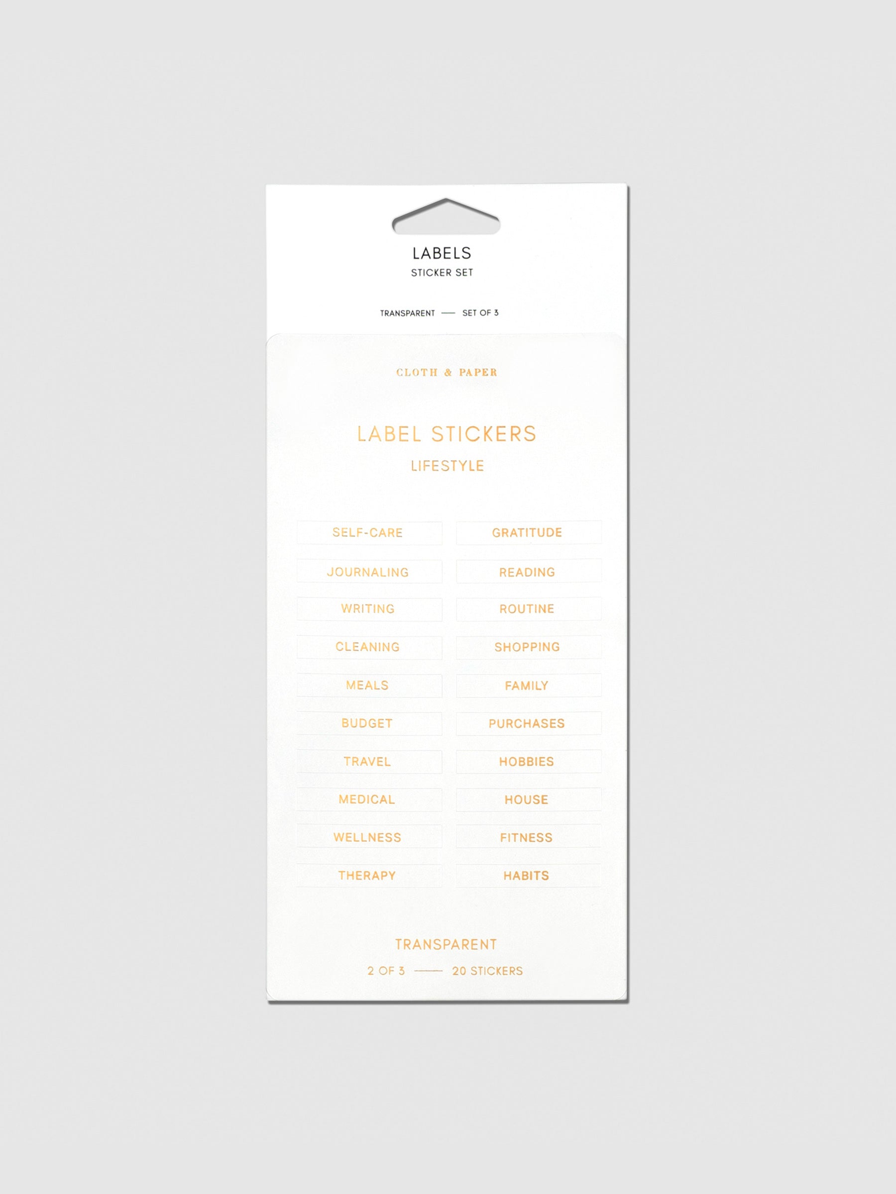 Label stickers in their packaging. The text on each sticker is gold.