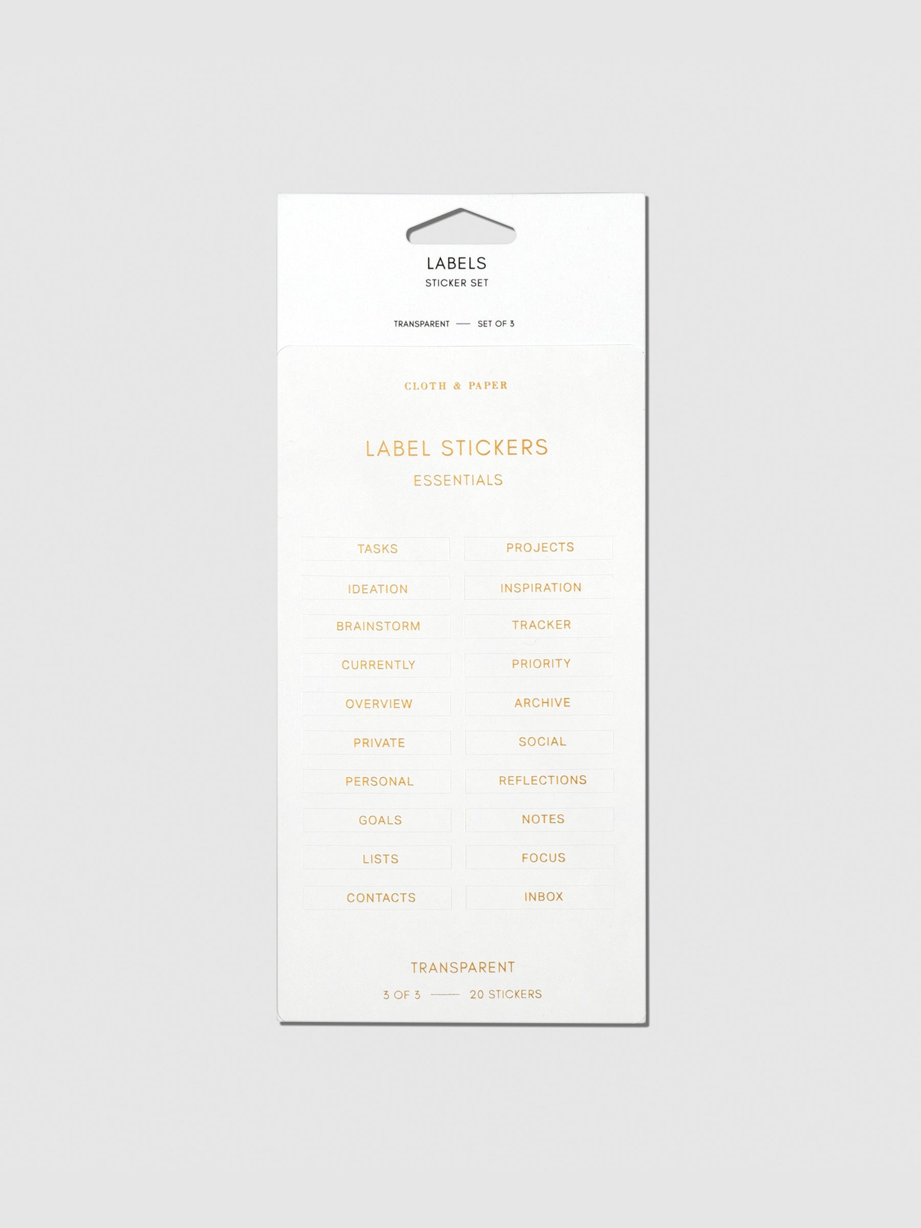 Label stickers in their packaging. The text on each sticker is gold.