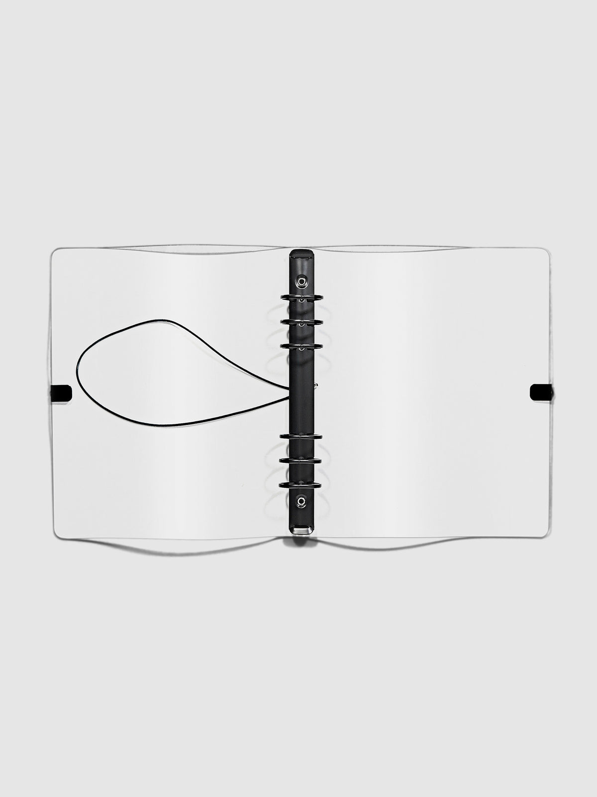 Open clear vinyl 6 ring agenda with black bungee shown open on a neutral background.