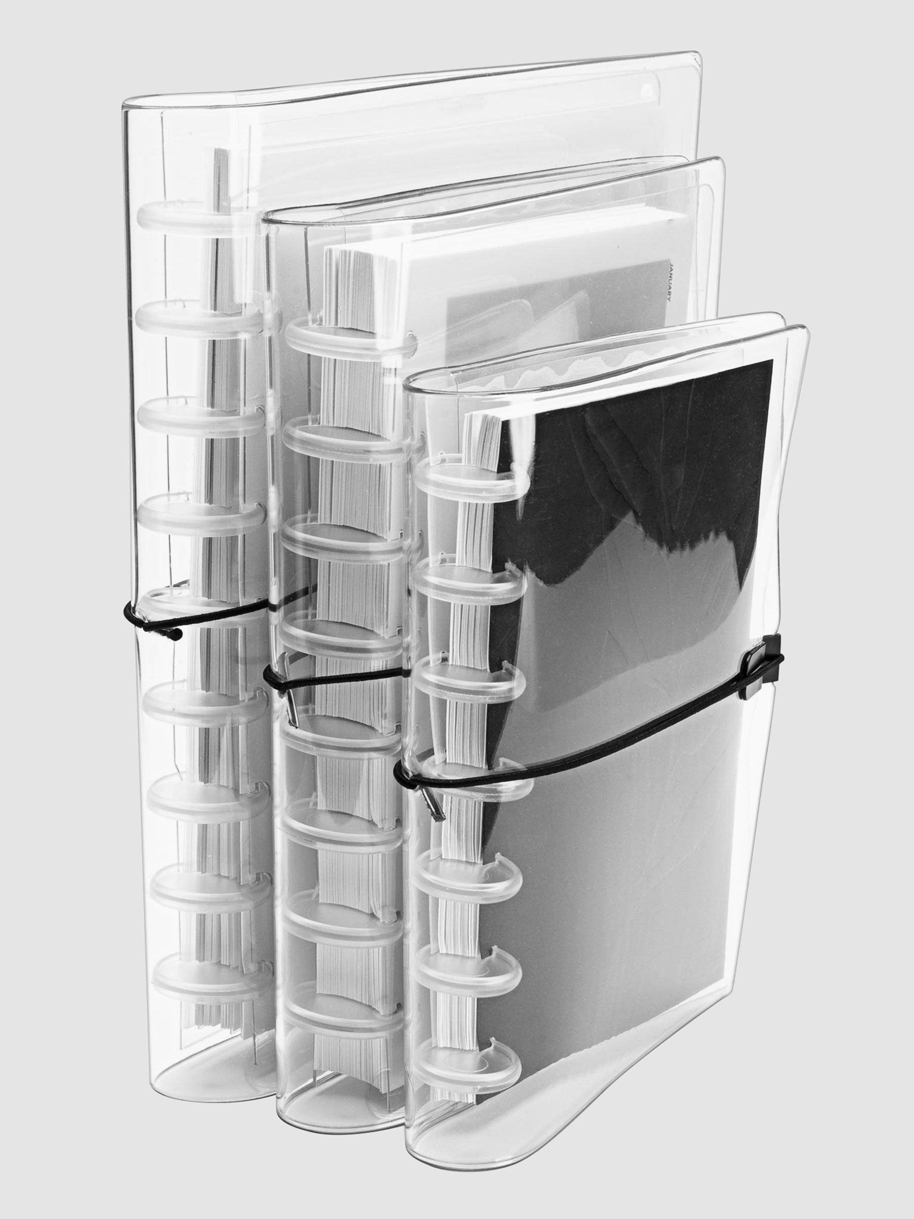 Small, Large, and HP Classic covers arranged in a row on a neutral background. Each cover is filled with a discbound planner system in respective sizing.