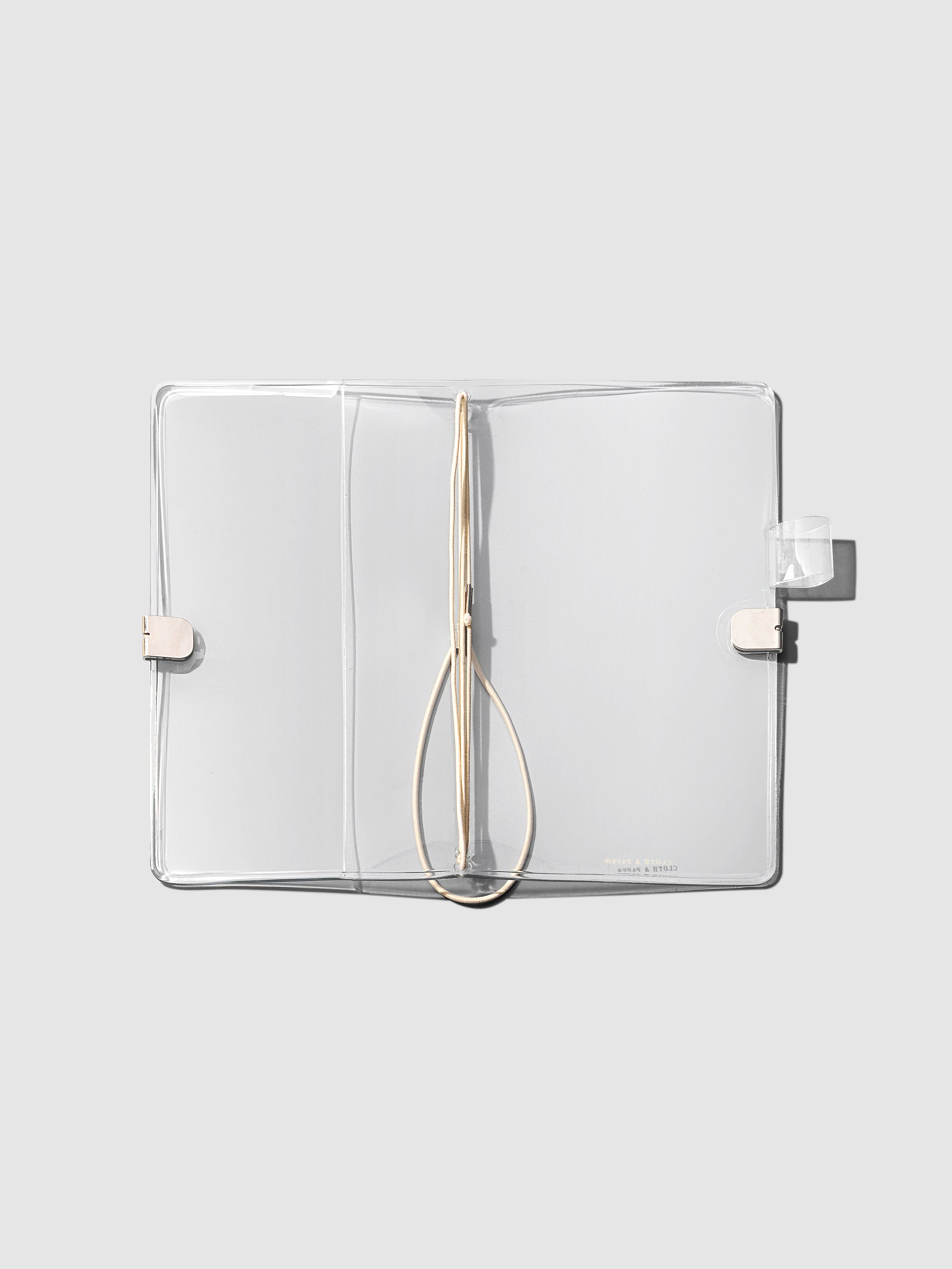 Clear Vinyl Planner, Travel Refillable Notebook Cover, Cloth and Paper. Cover shown open on a neutral background.