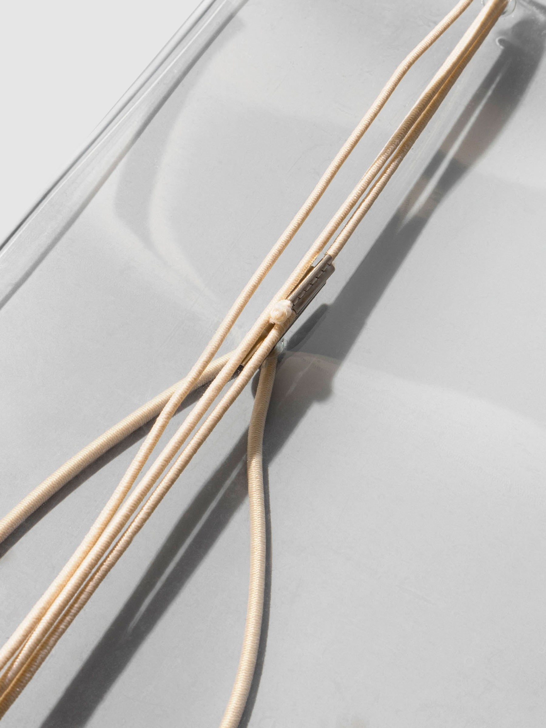 Closeup of beige bungee string closure.