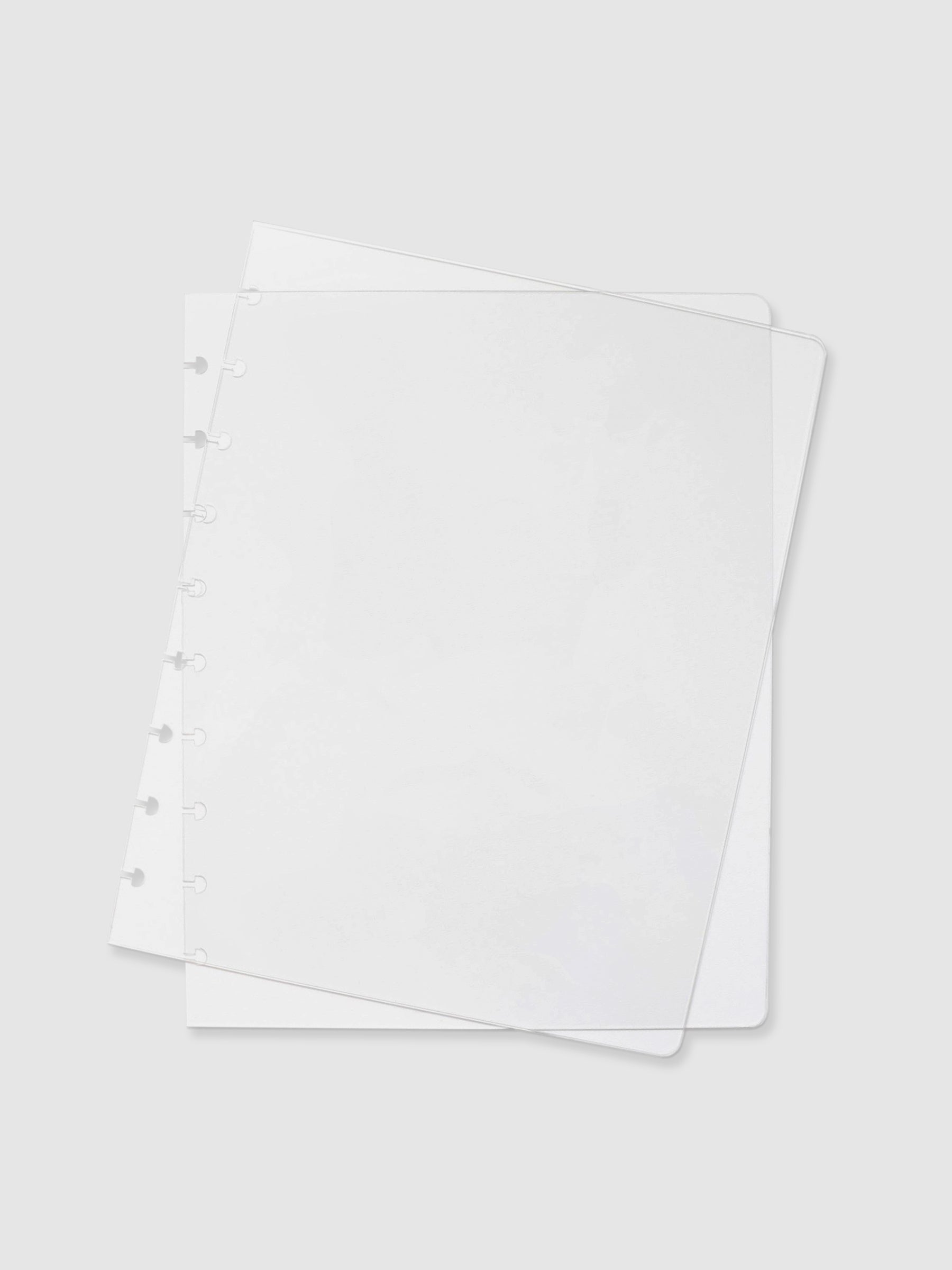 Crystal Clear Discbound Notebook Cover, HP Classic, Cloth and Paper. Two transparent notebook covers laid on top of one another with the top cover tilted slightly to the right.