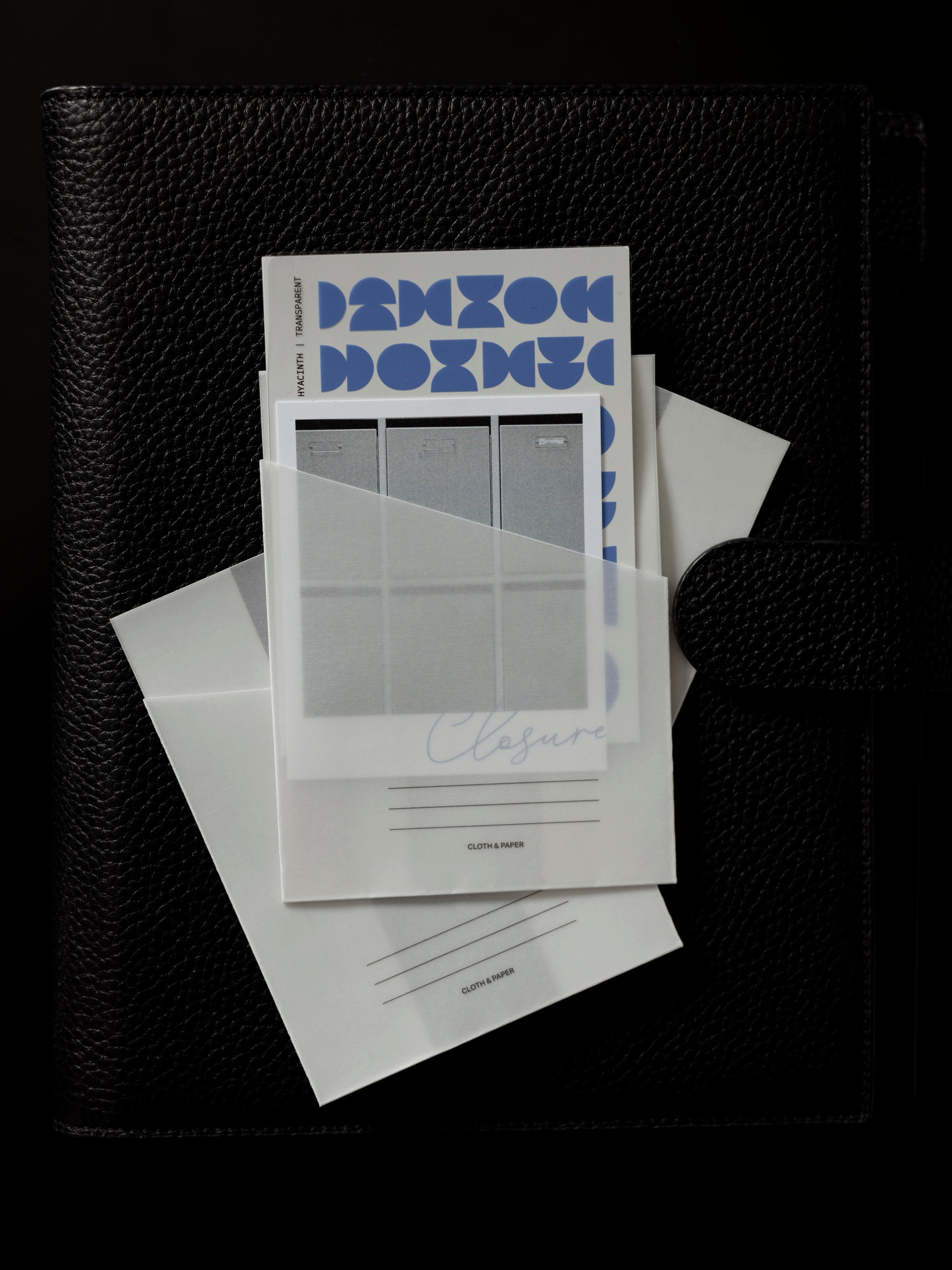 Adhesive Vellum Pocket Set shown with items inside against a dark background.