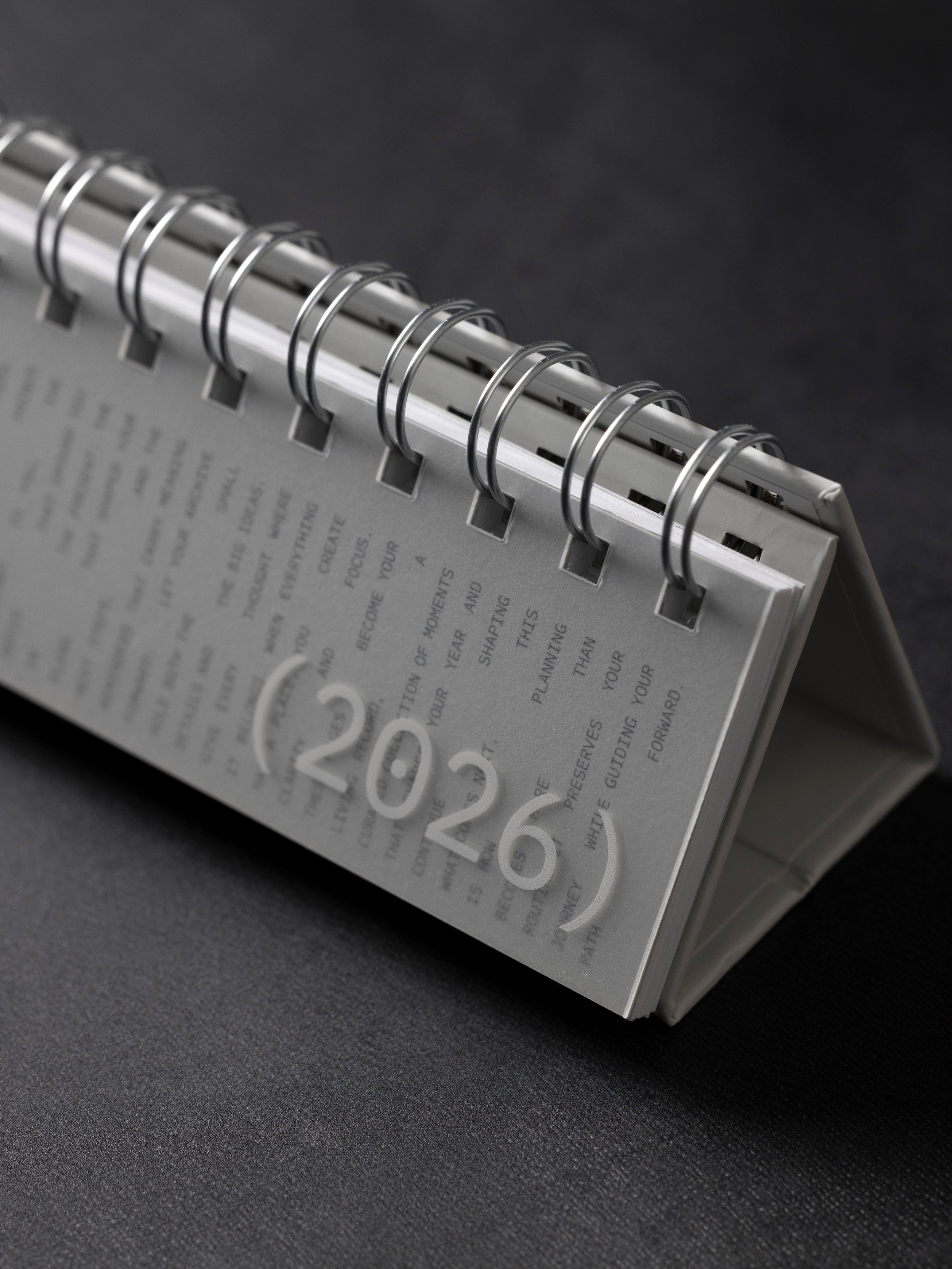 2026 Spiral Desk Calendar against a dark background