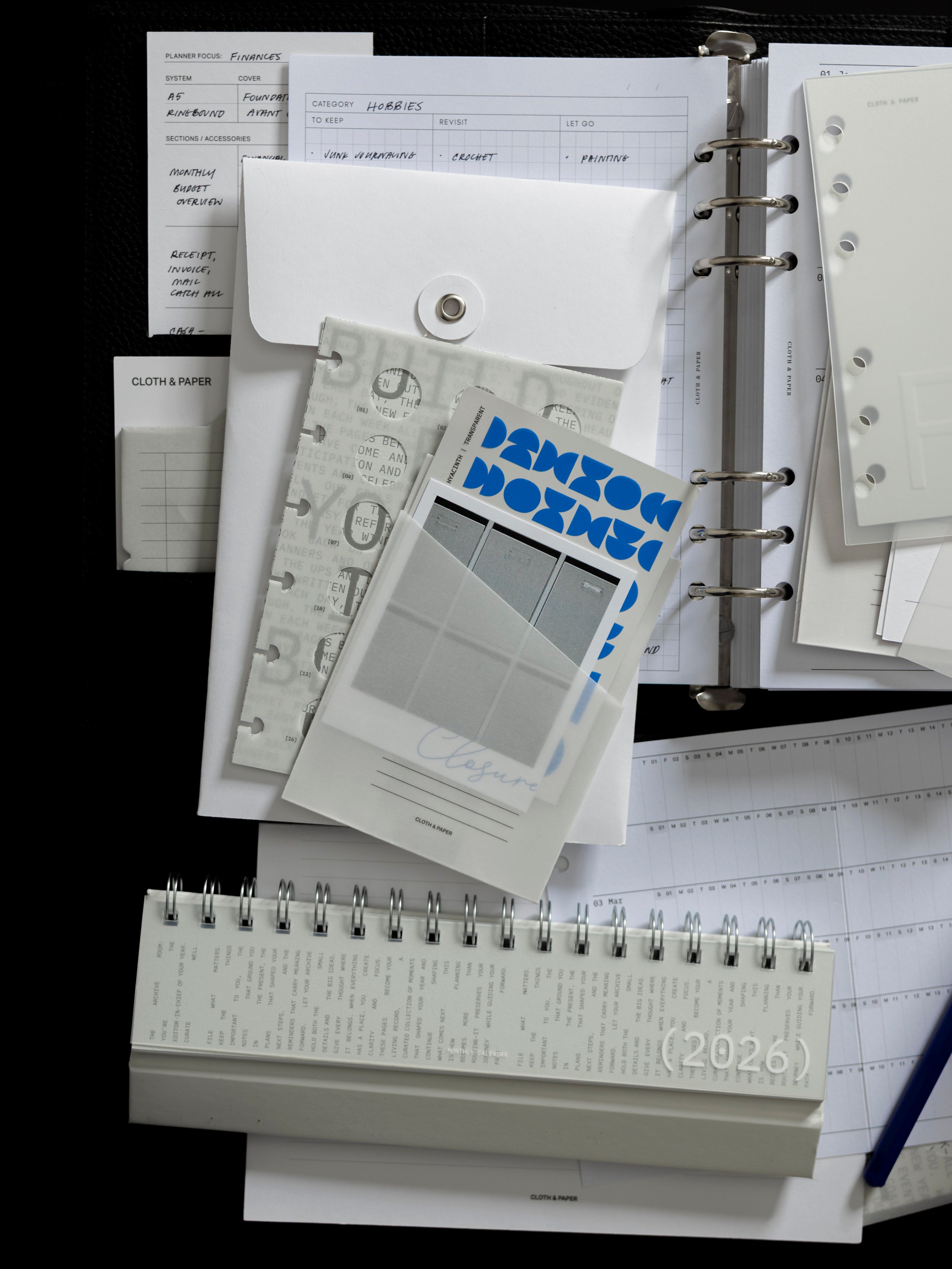 Selection of products from the December 2025 Intention Box including desk accessories, stickers, stationery, and more.