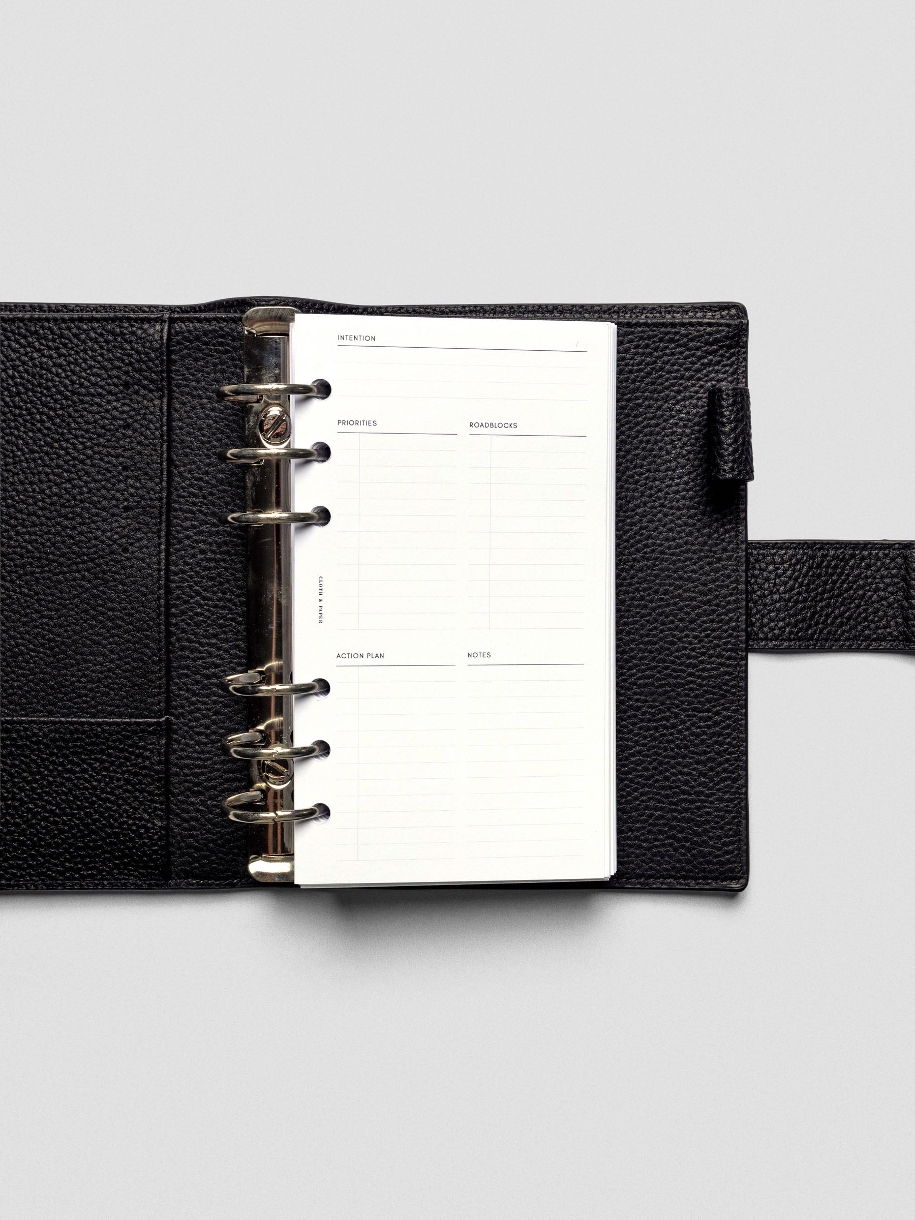 Daily Intention Planner Inserts show blank in Personal size ring bound in a leather cover.