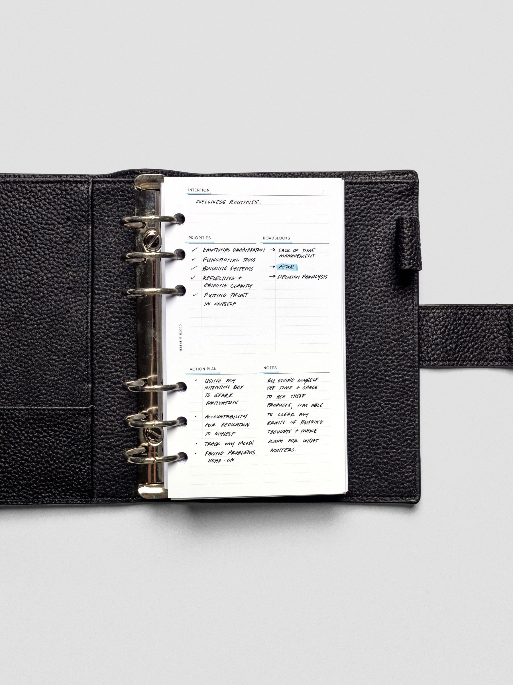 Daily Intention Planner Inserts show filled out in Personal size ring bound in a leather cover.