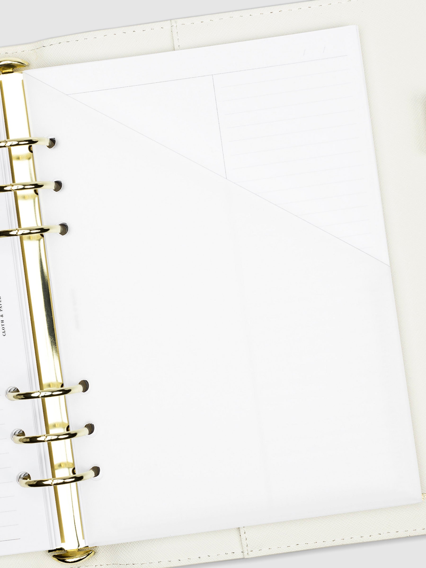 Folder in use inside a white leather agenda.