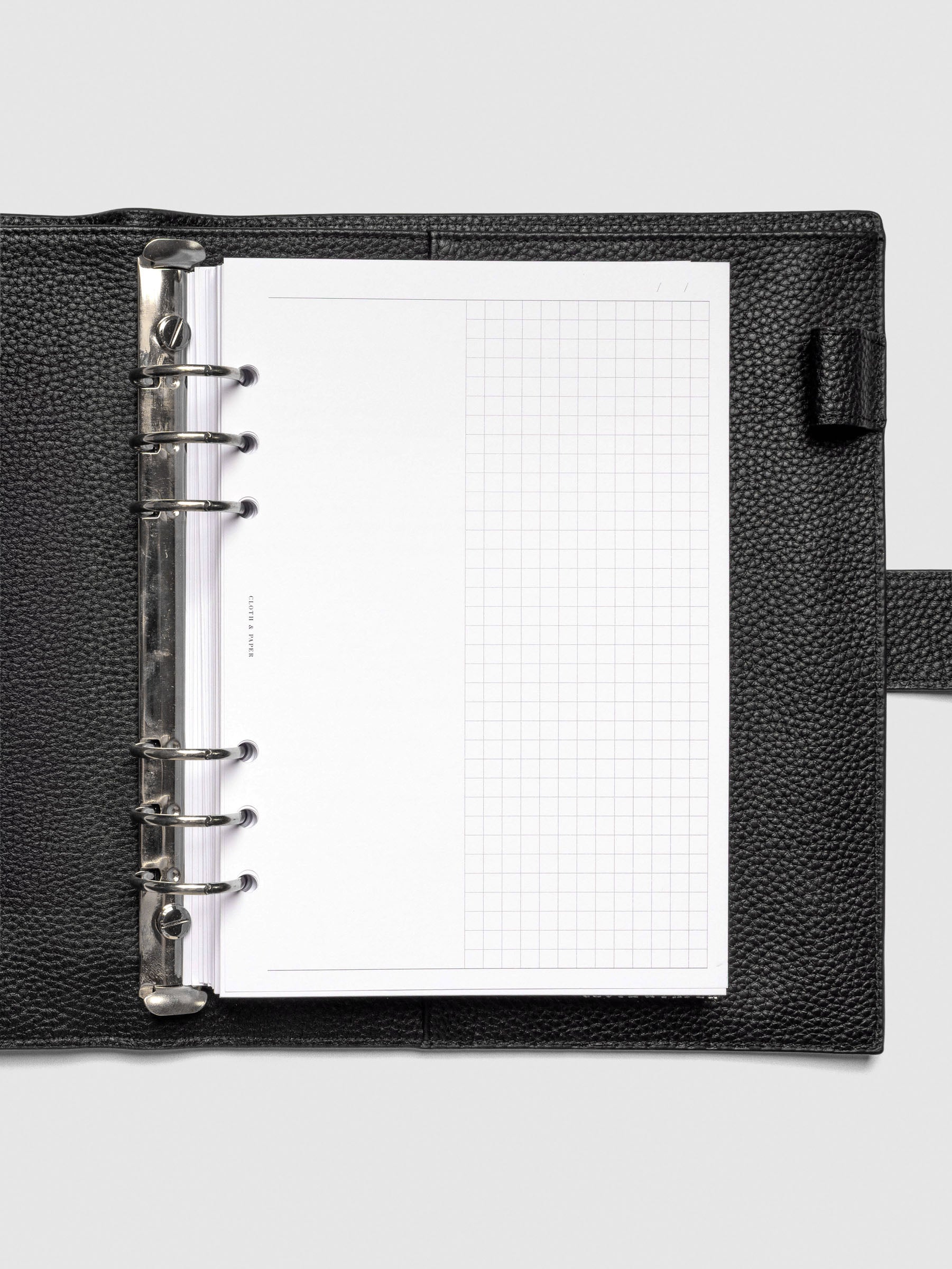 Inserts in use inside a black leather planner.