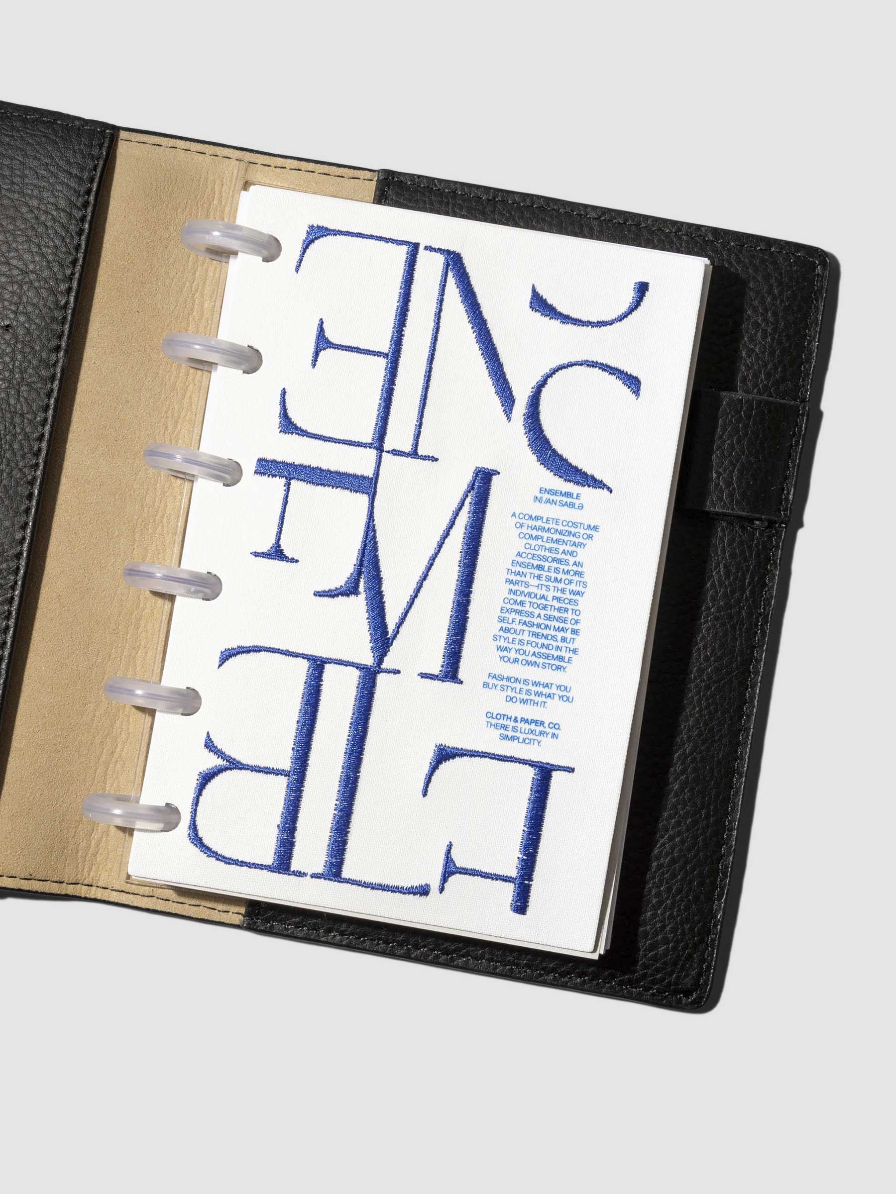 Dashboard displayed inside a leather agenda on a neutral background. Size shown is CP Petite.