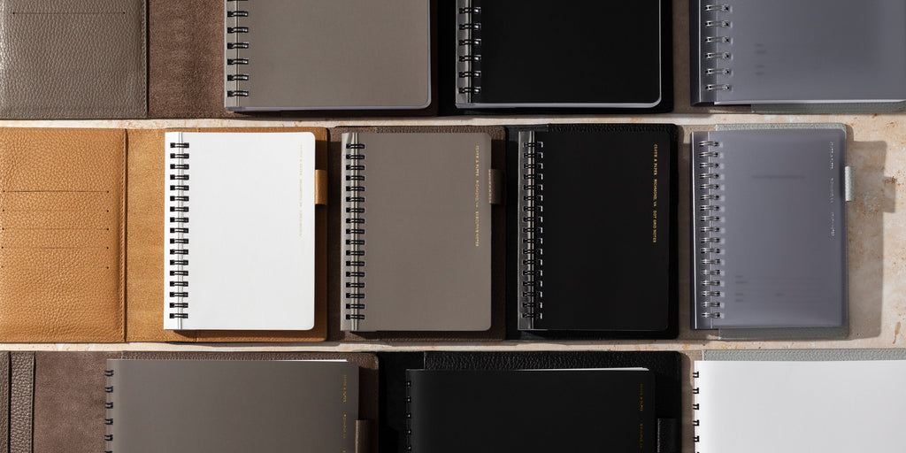 A collection of España Spiral Notebooks side by side and inside opened Heirloom Leather Folios.