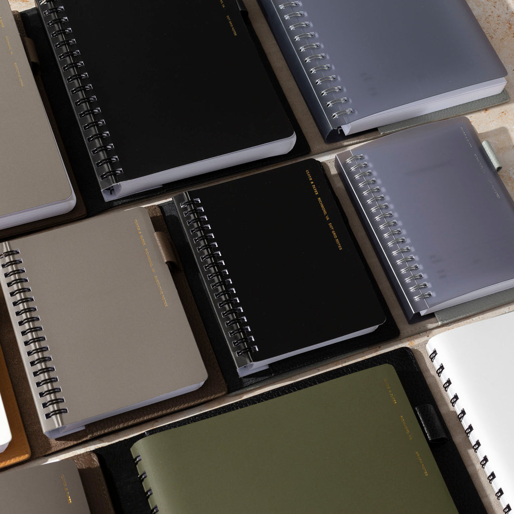 A collection of España Notebook in various sizes are layered inside Heirloom Folios.