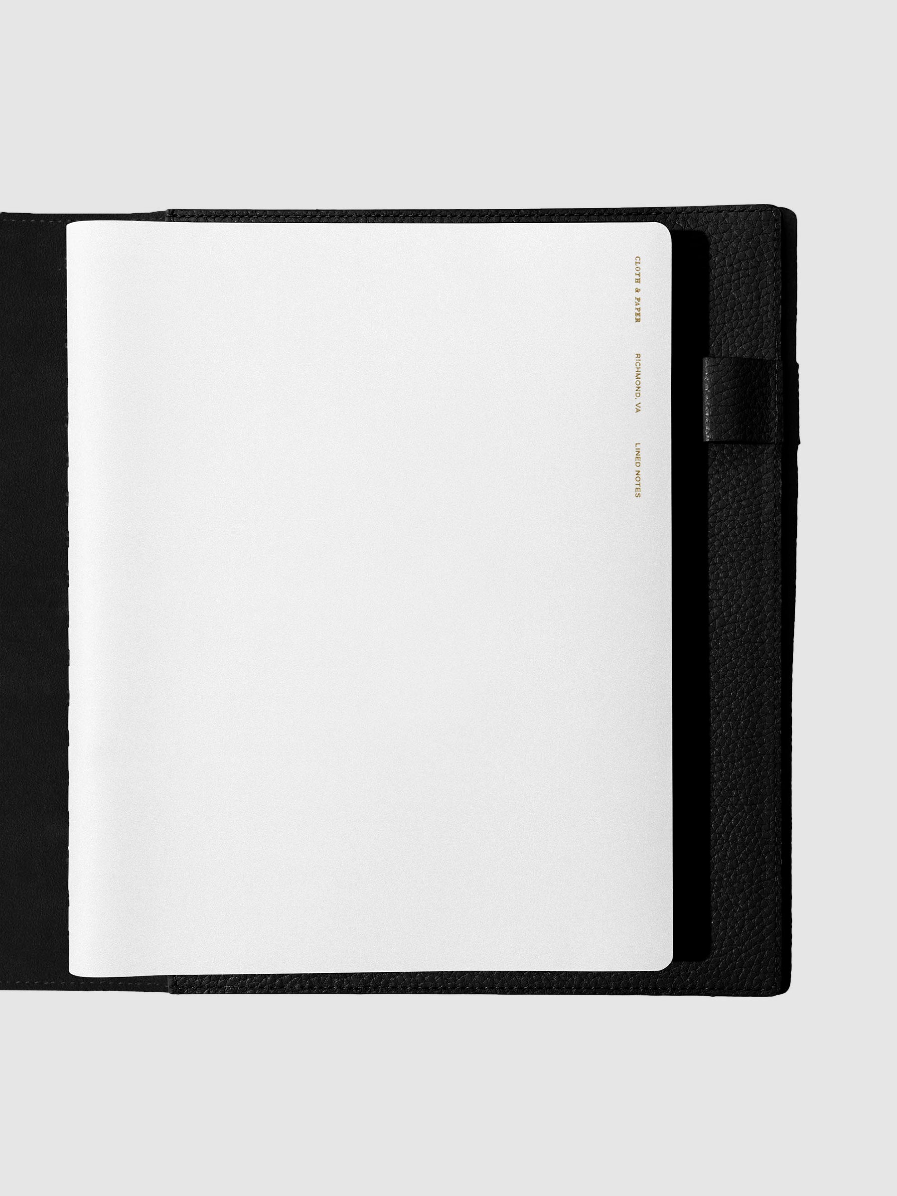 Notebook shown closed inside a black leather agenda. Color shown is Ash.