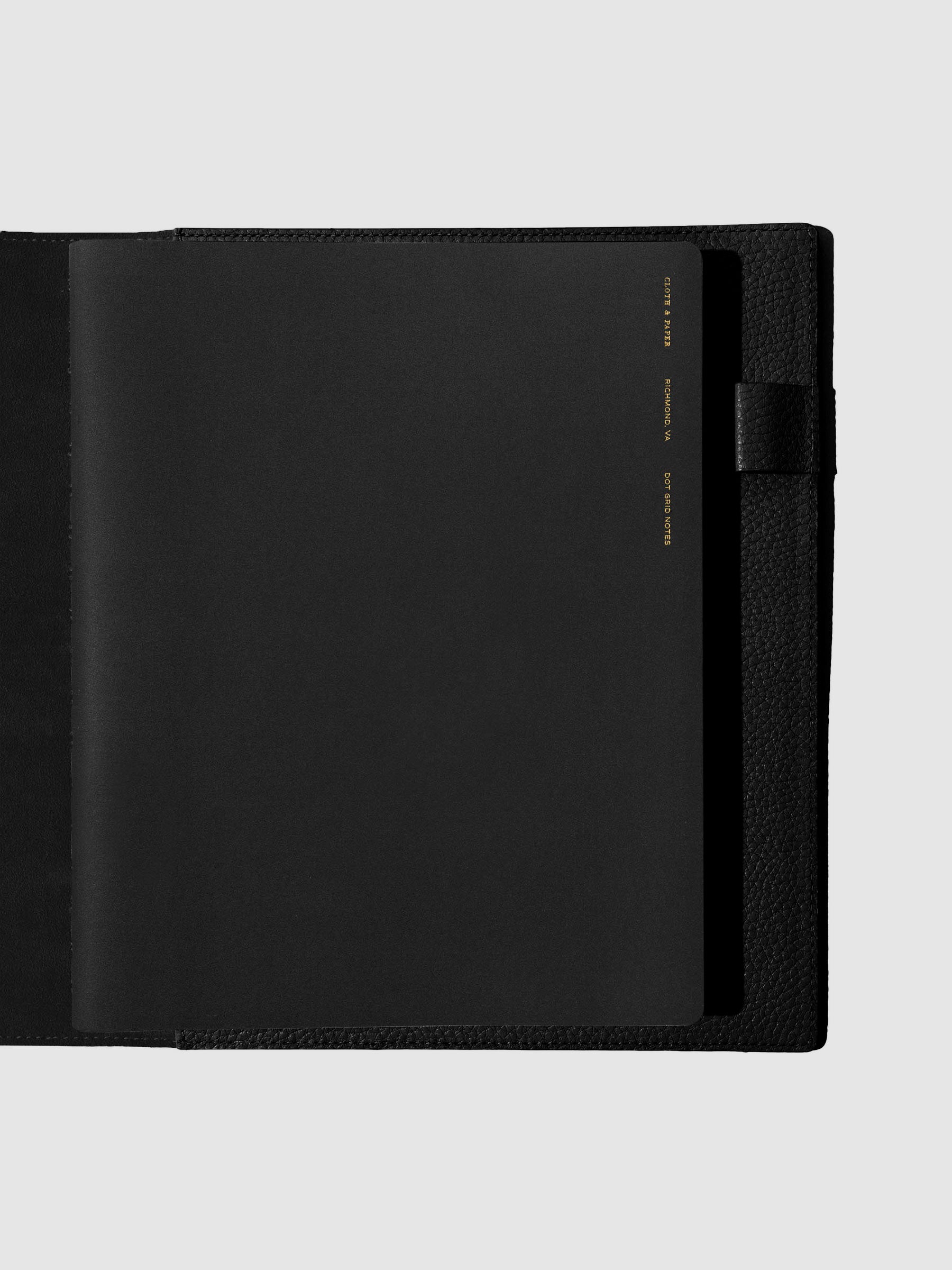 Notebook shown closed inside a black leather agenda. Color shown is Avant Garde.