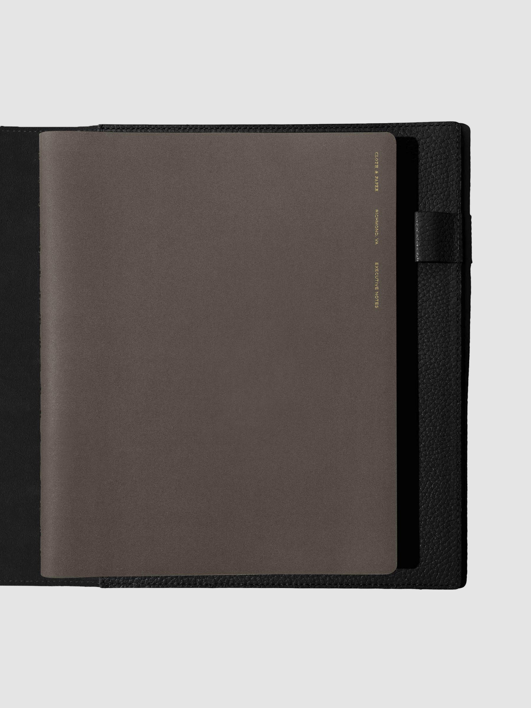 Notebook shown closed inside a black leather agenda. Color shown is Cafe Noir.