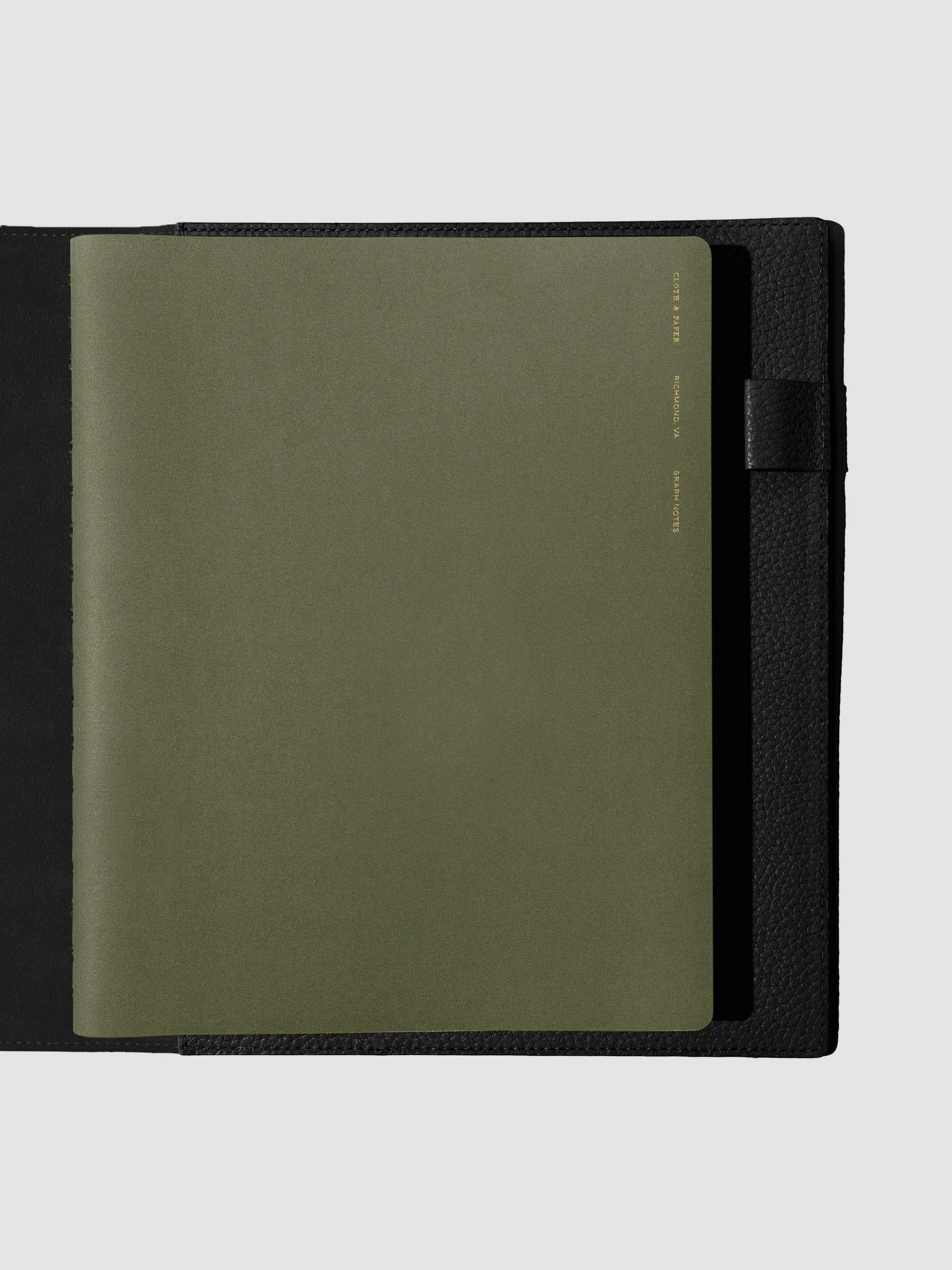 Notebook shown closed inside a black leather agenda. Color shown is Olive.
