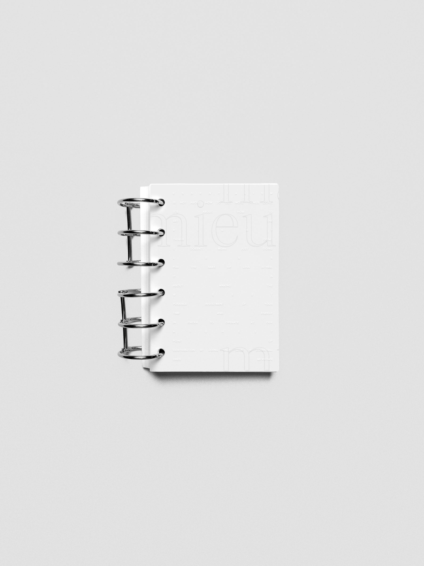 Essentialism Dashboard Duo reading "moins mai mieux" in size Pocket shown ringbound.