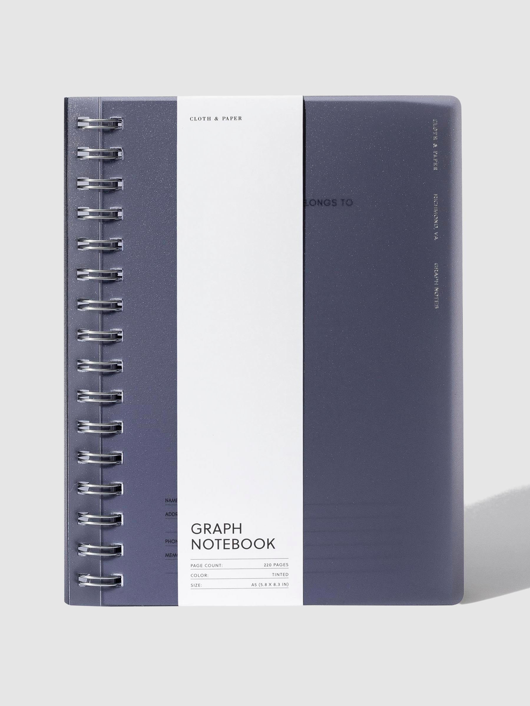 Tinted plastic notebook displayed with its packaging on a neutral background.