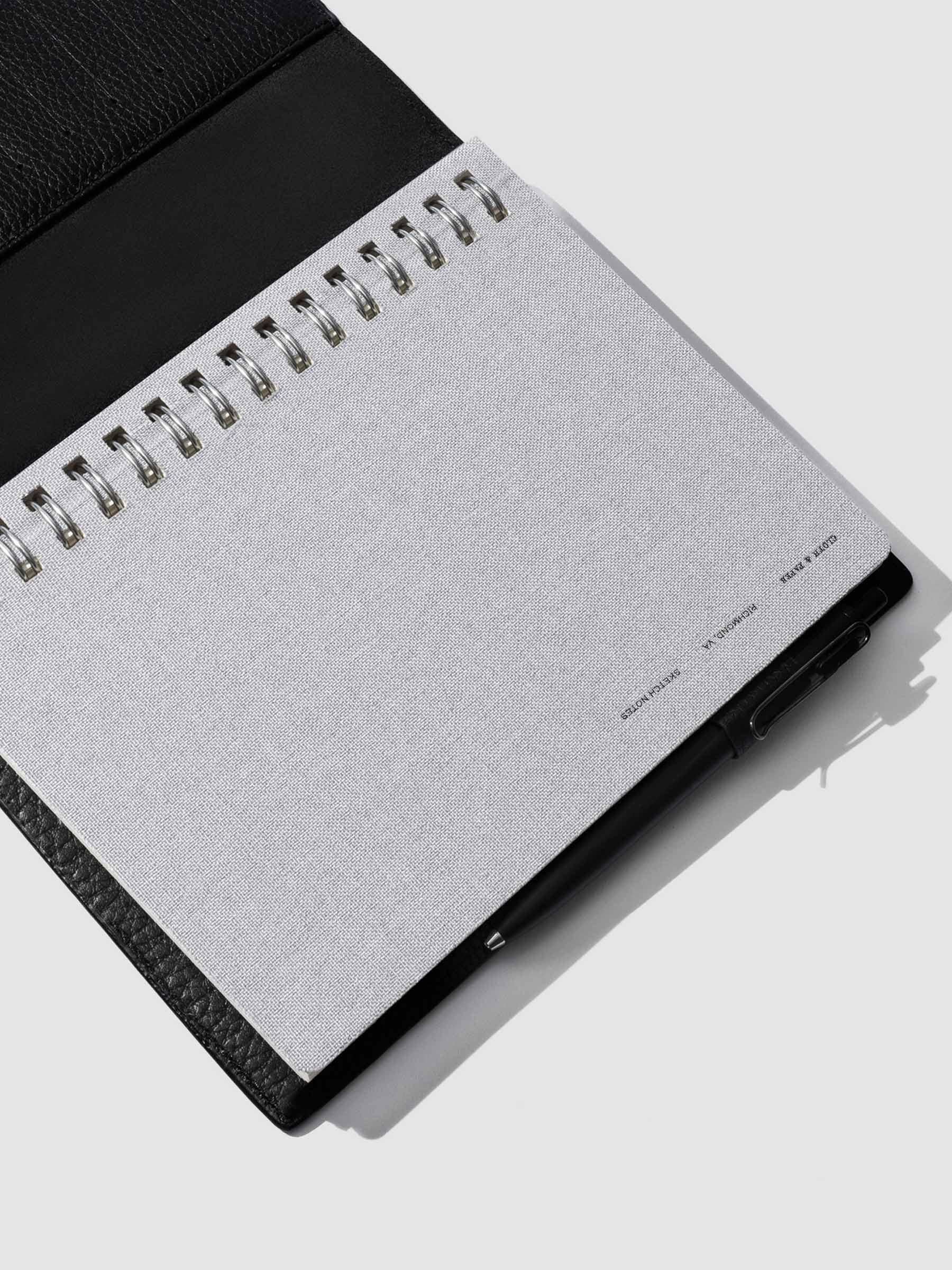 Linen notebook displayed in a black leather folio.