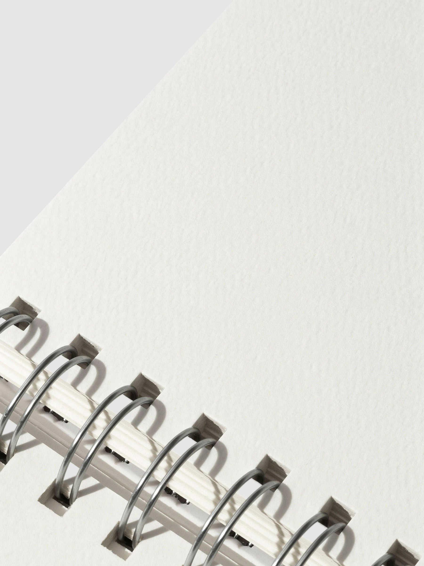 Closeup of textured sketchbook paper.